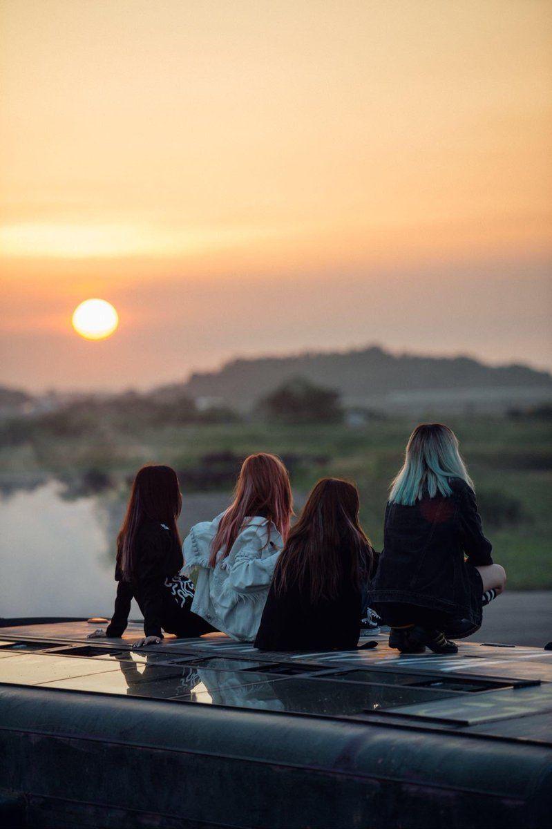 A scene from BlackPink's Stay music video with a sunset scenery that