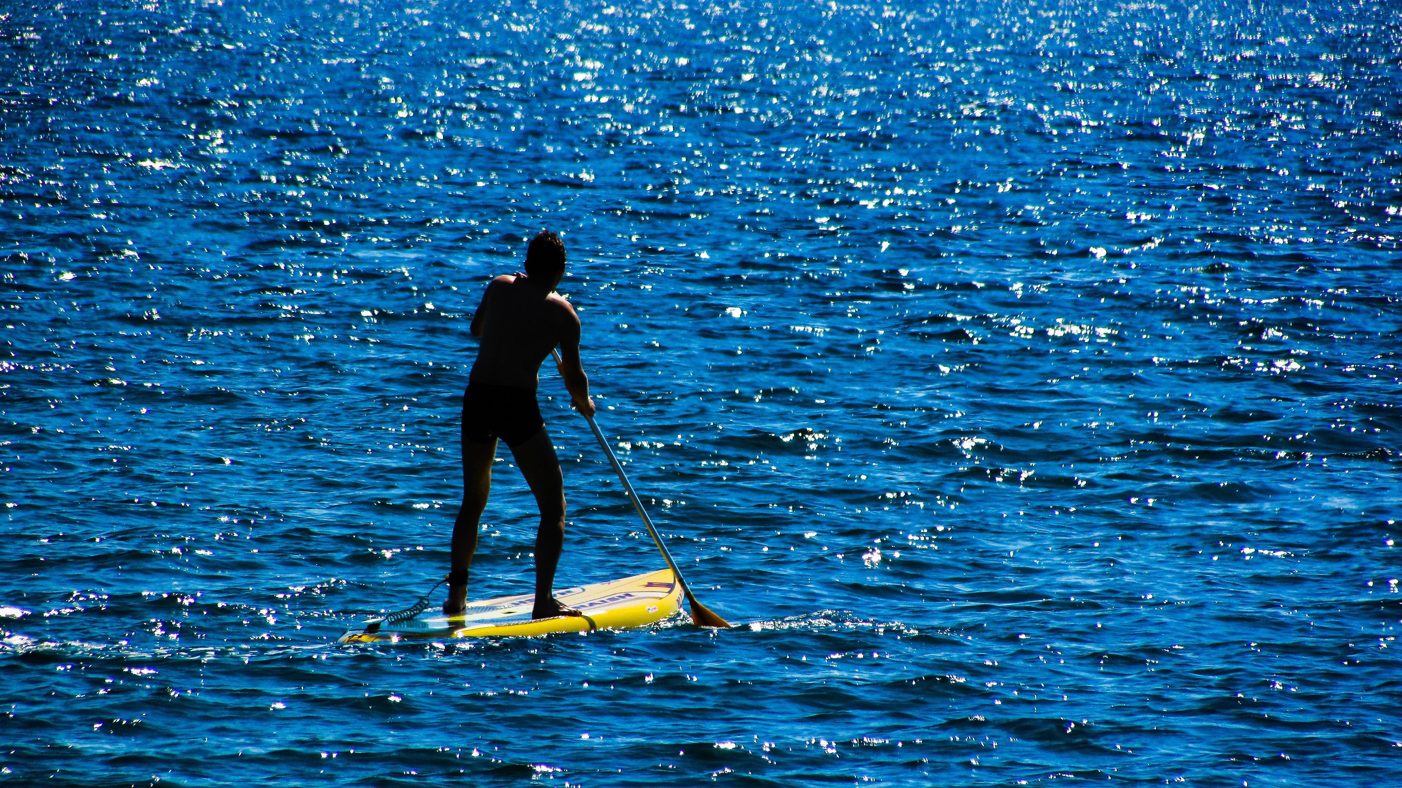 Person Paddling While Standing on Yellow Paddleboard · Free