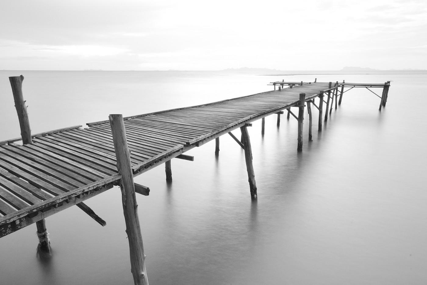 Wooden pier extending into foggy sea, black white wall mural. Se8531
