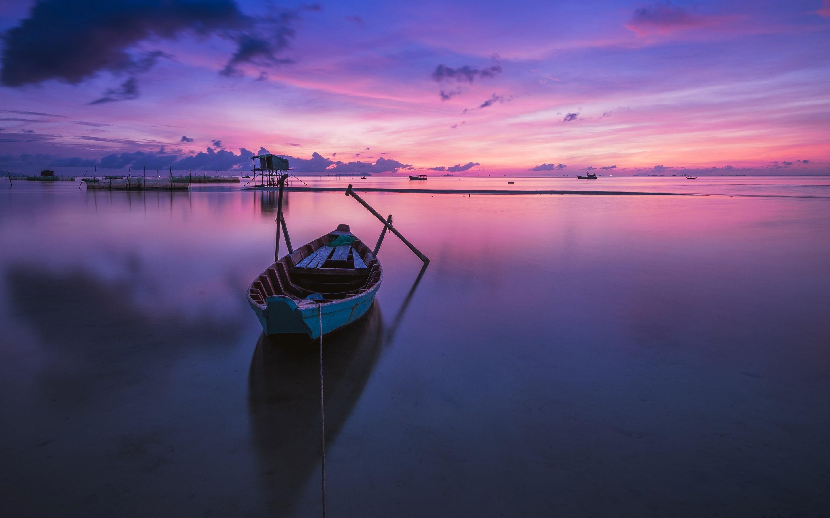 A boat at sunset Wallpaper
