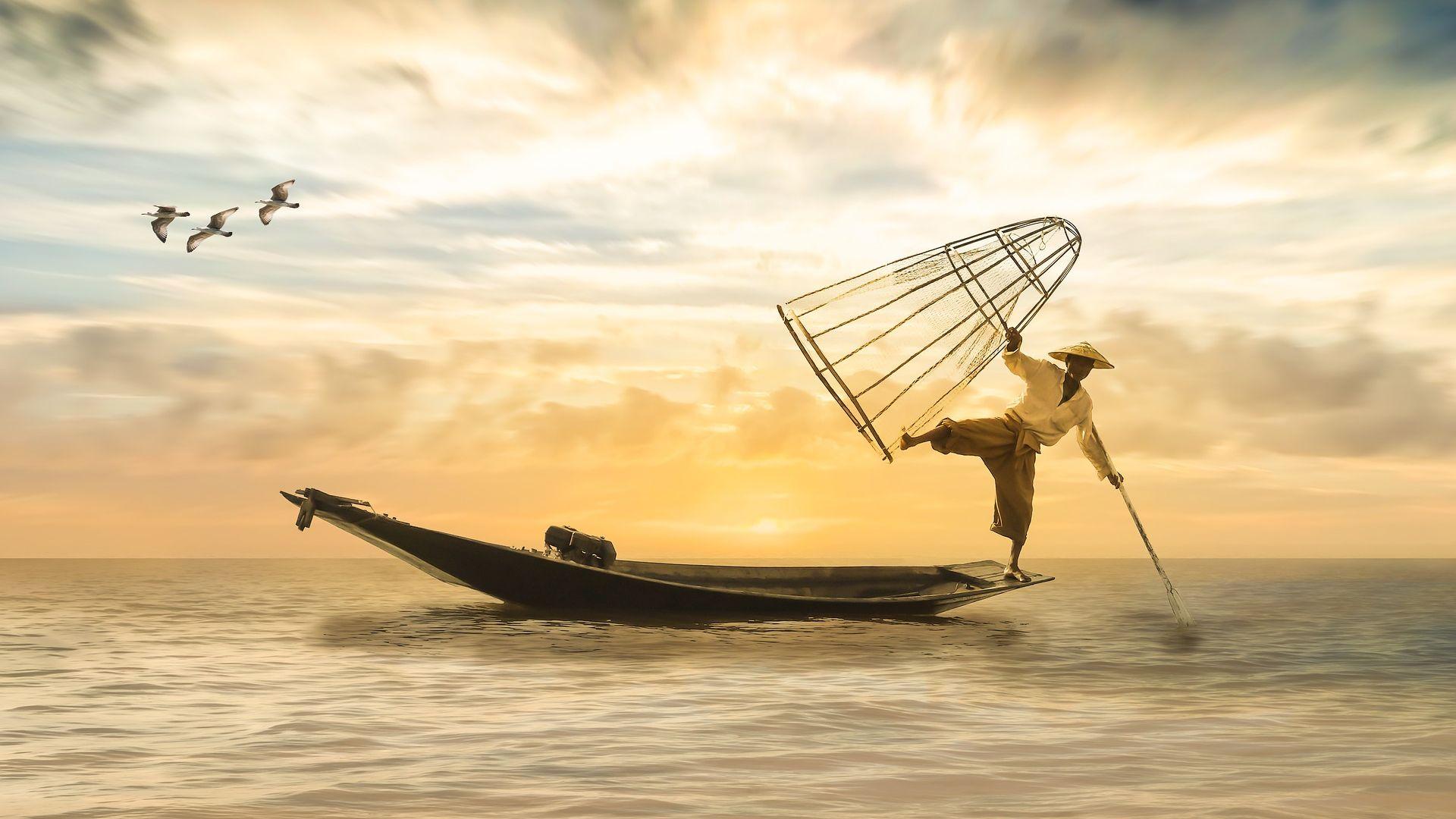 Fisherman Fishing Fish from Boat in Sunset Wallpaper