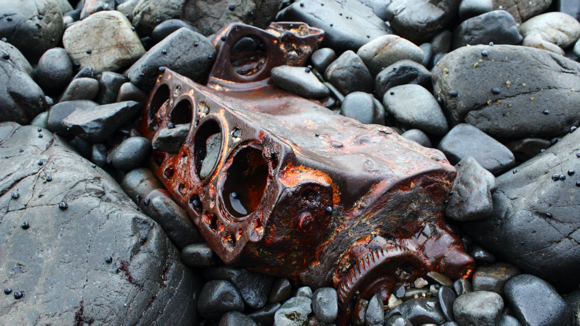 An old engine wearing away with the tides. Found in a very