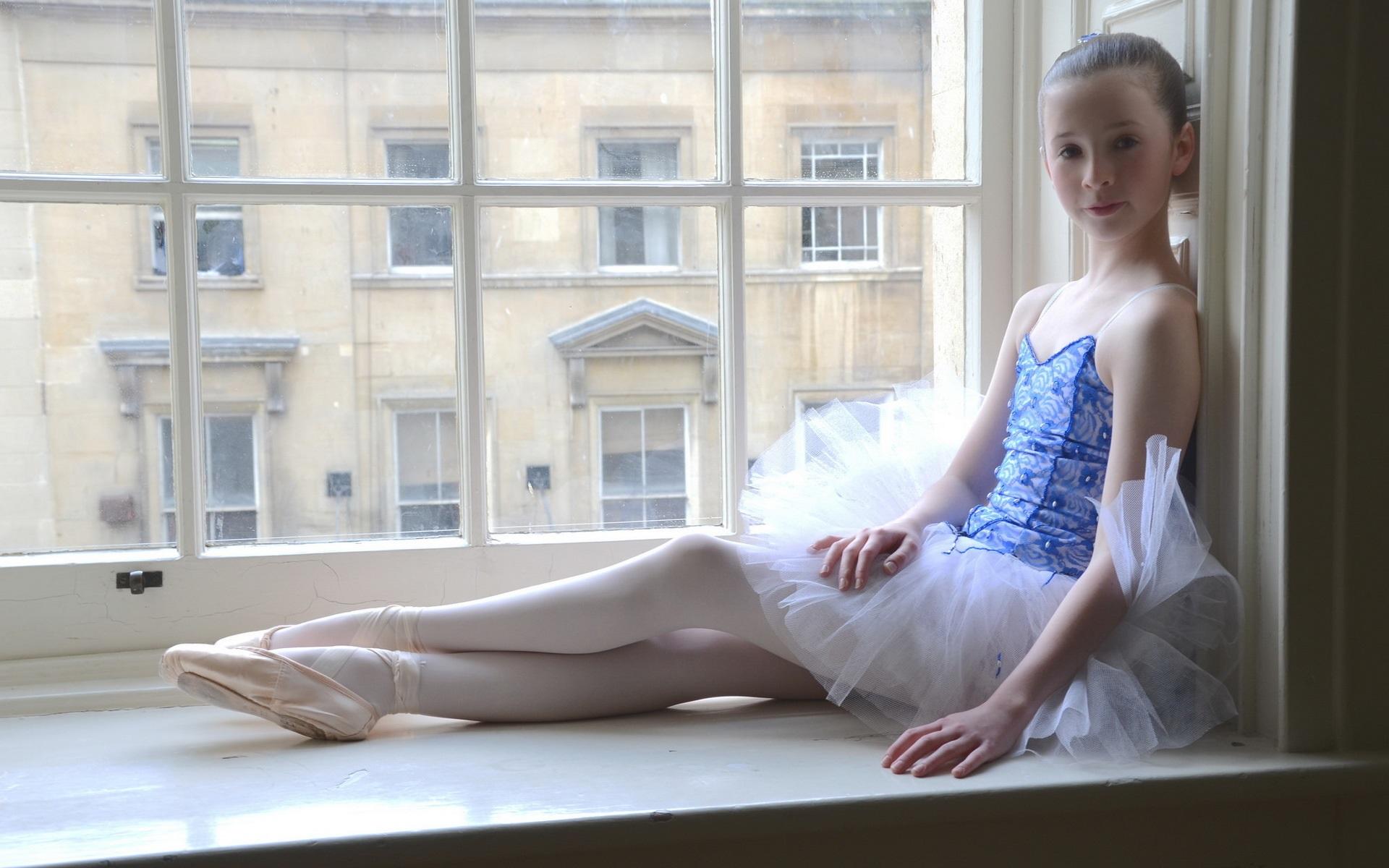 Wallpaper Cute ballerina little girl sit at window side