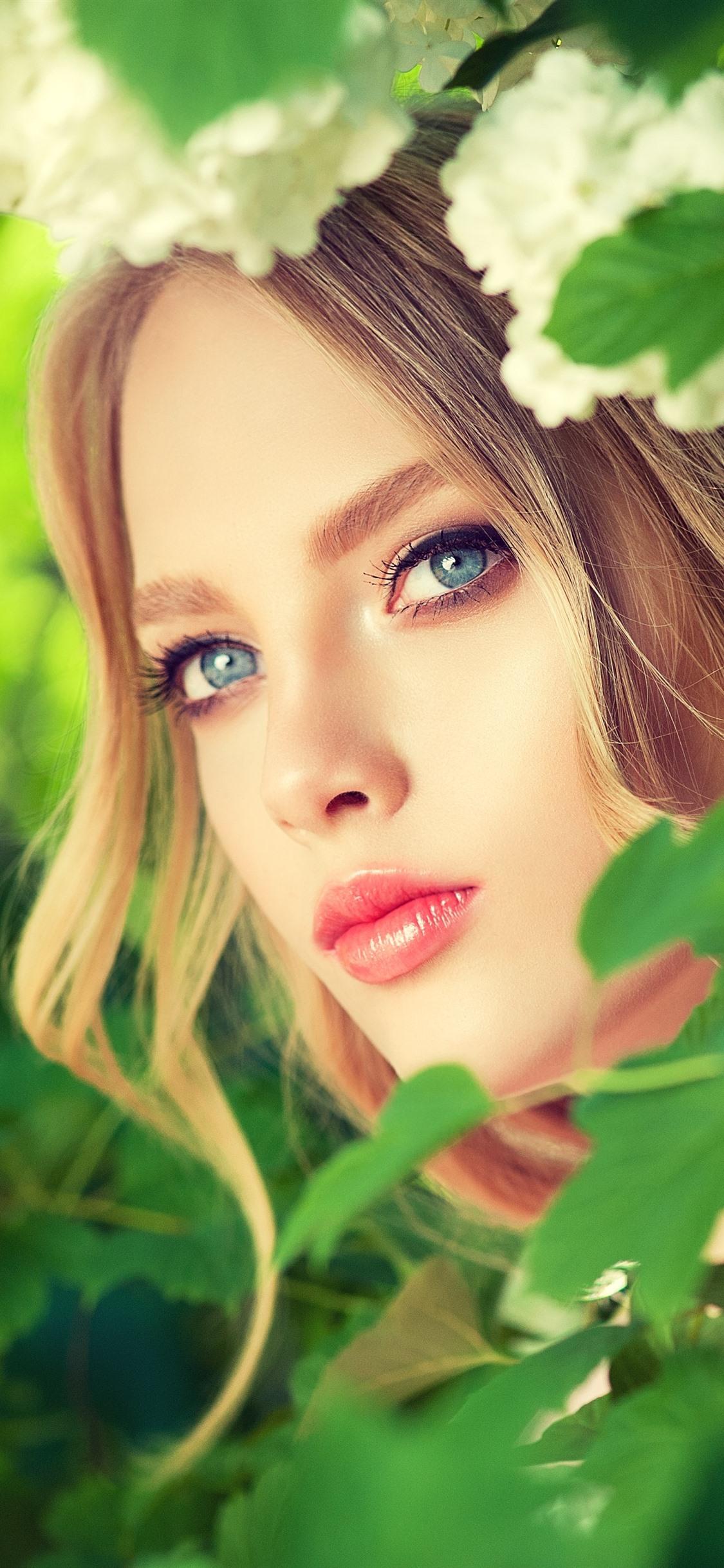 Blonde girl, blue eyes, green leaves, flowers 1242x2688