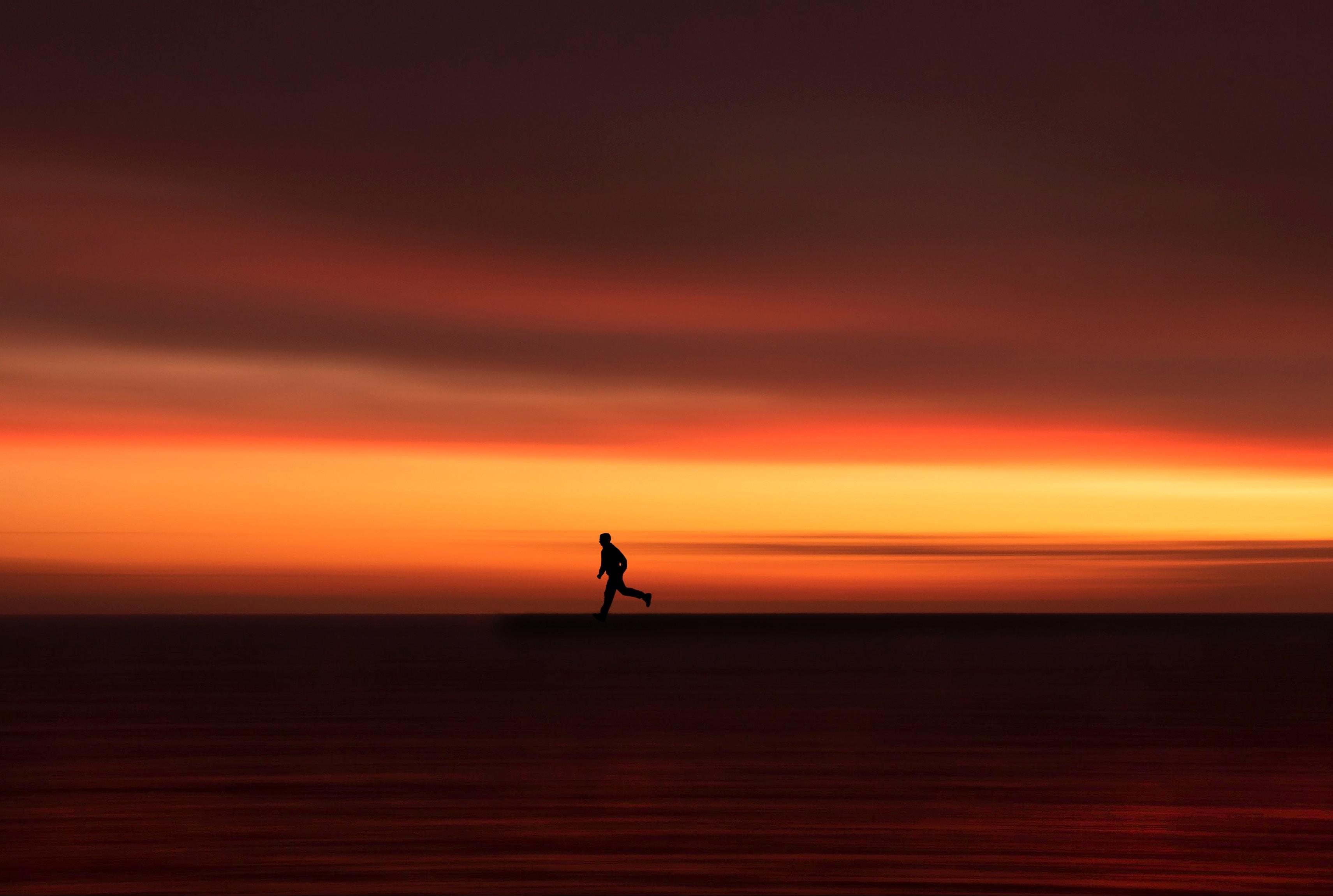 Silhouette Horizon Running Twilight Sunset Red Stock