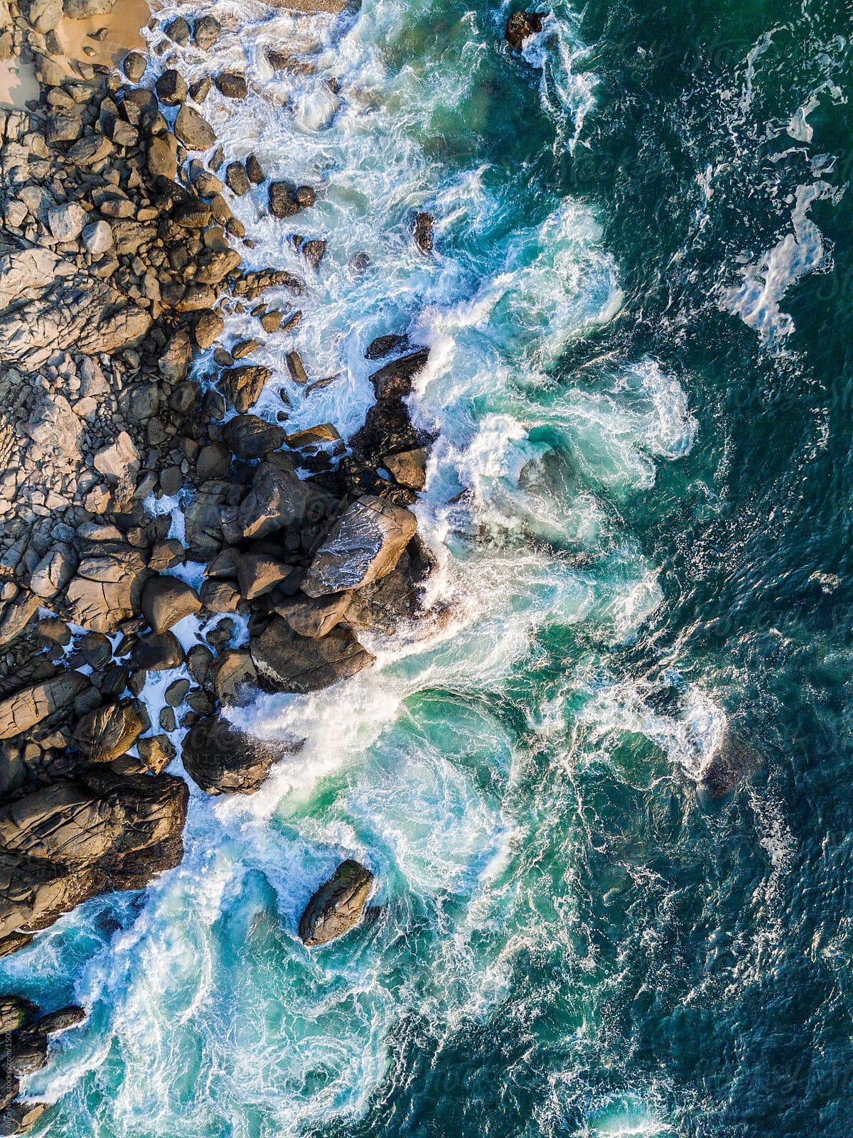 View To A Rocky Beach With Waves Crashing On It