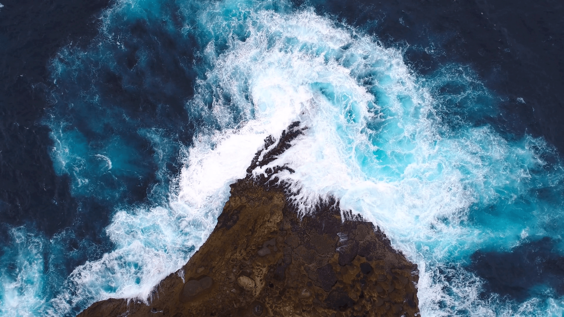 Aerial view by drone 4k camera. Ocean with waves and rocky cliff. Cliff with waves crashing against a rocky shore, Nusa Penida, Indonesia. zoom