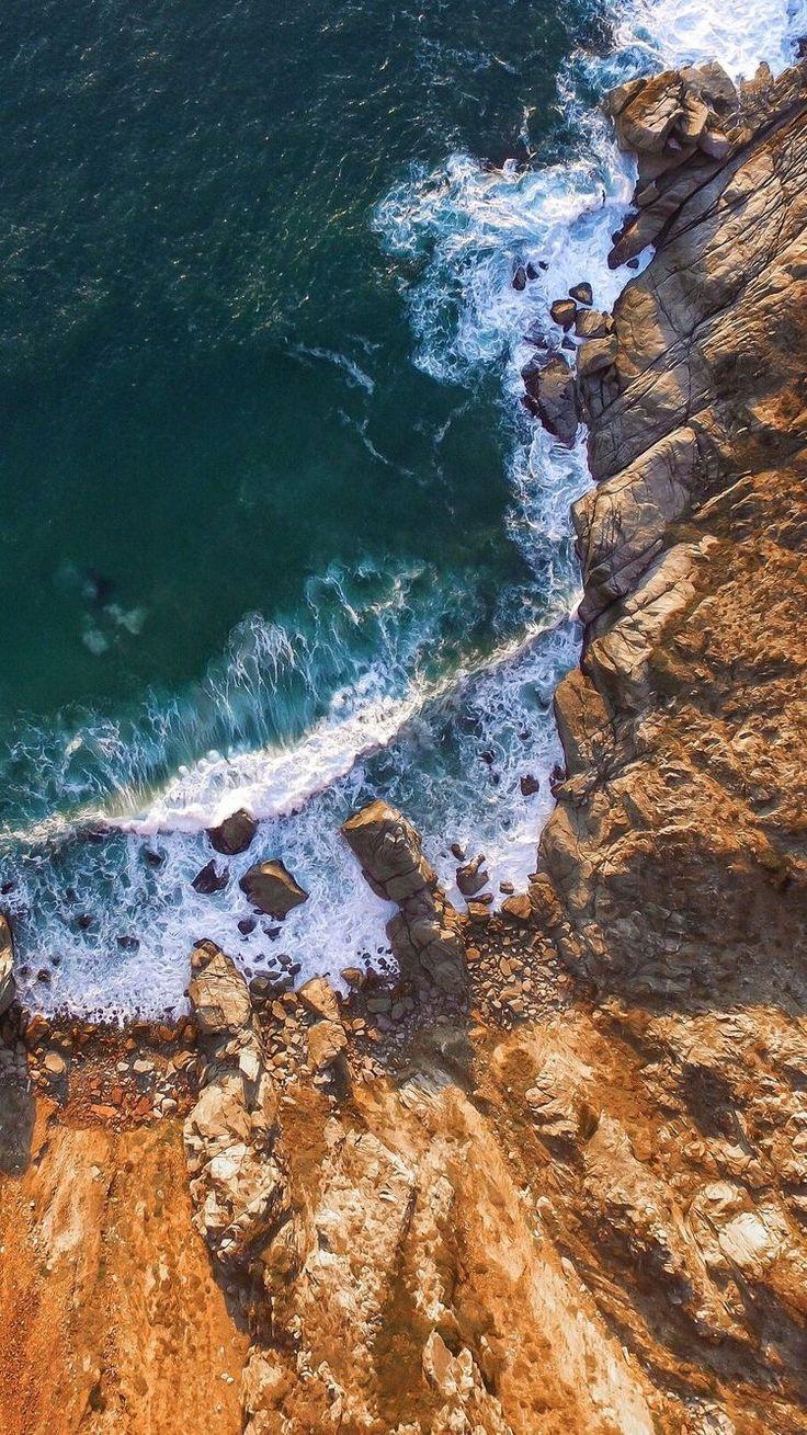 A ragged cliff line + an aerial view of the crashing waves