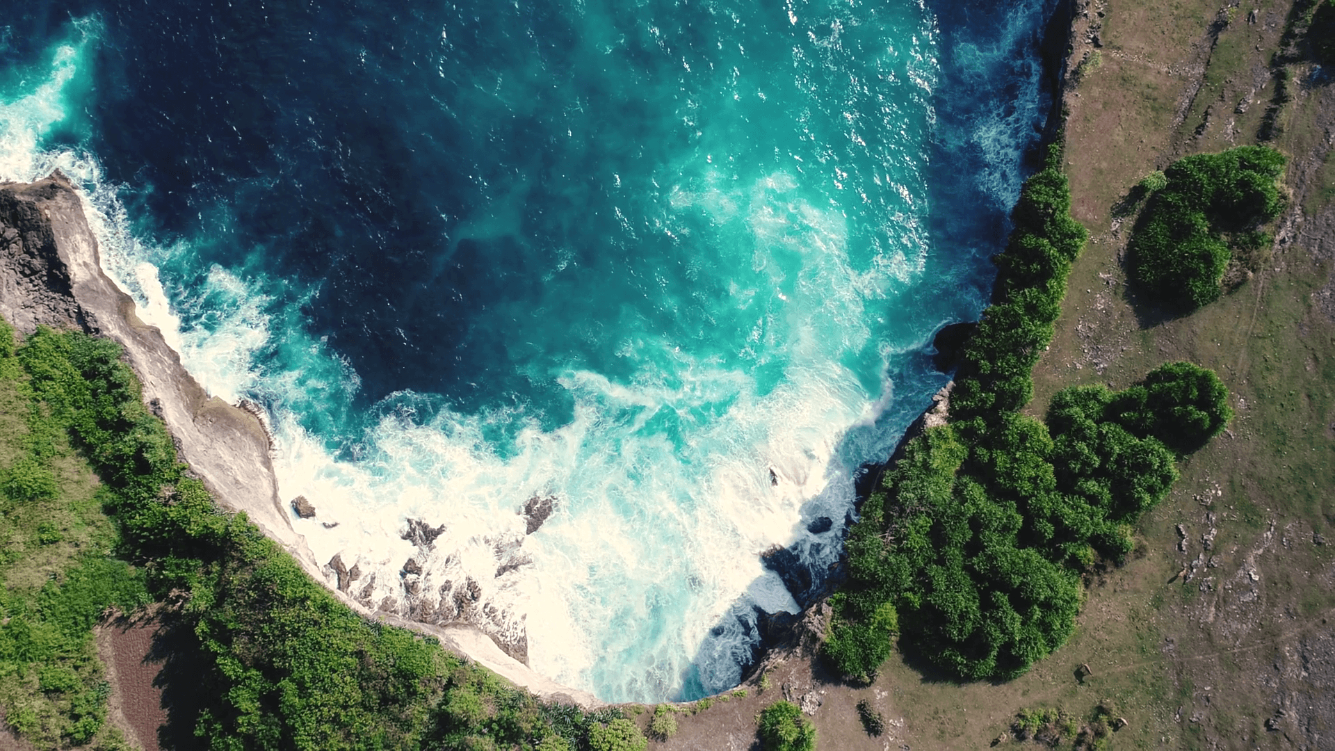 Aerial view by drone 4k camera. Rocky coast with high cliffs, sea surf with breaking waves on the coast, Nusa Penida, Pasih Uug, Broken Beach. Ocean
