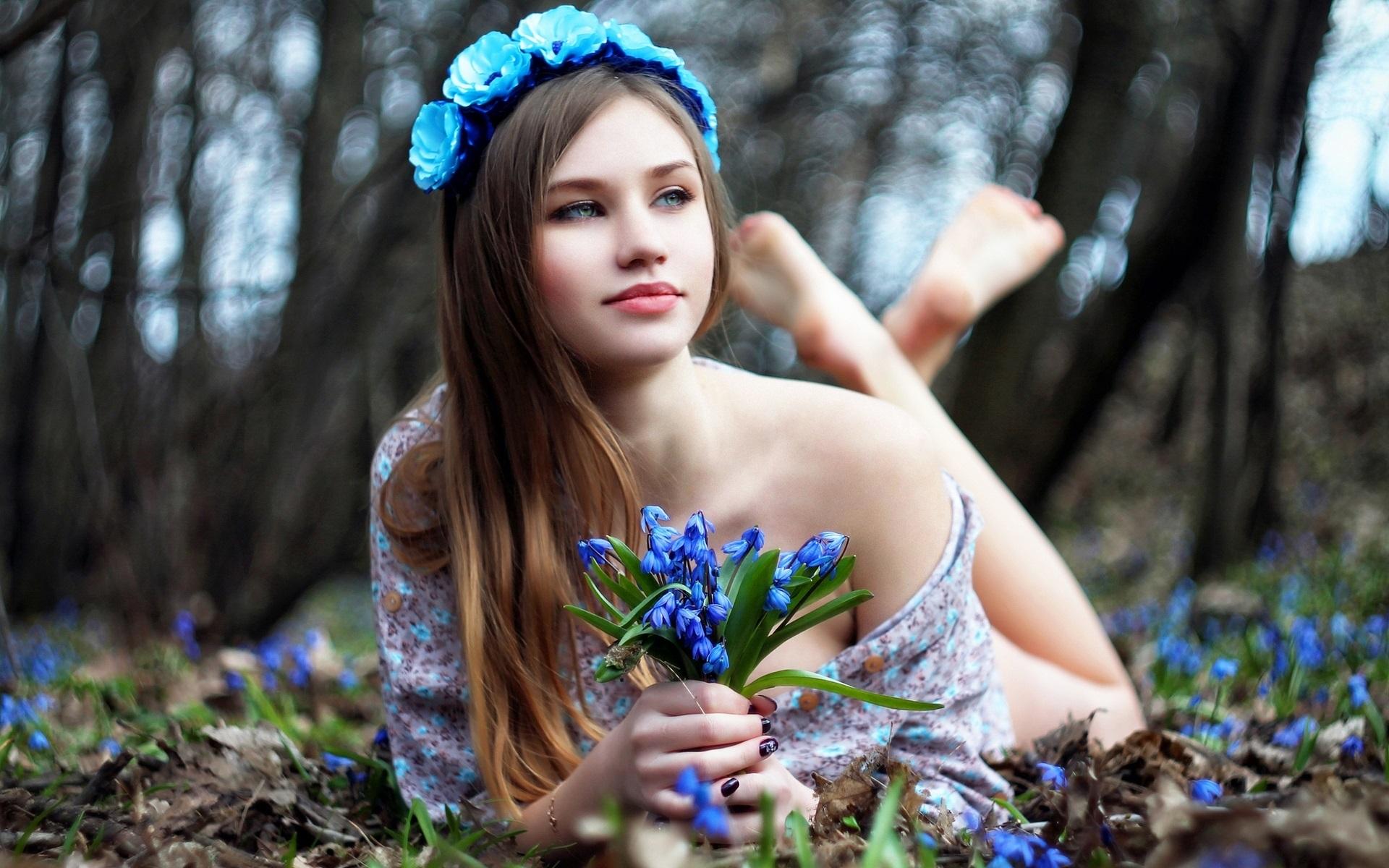 Wallpaper Lovely girl and blue flowers, lying on ground