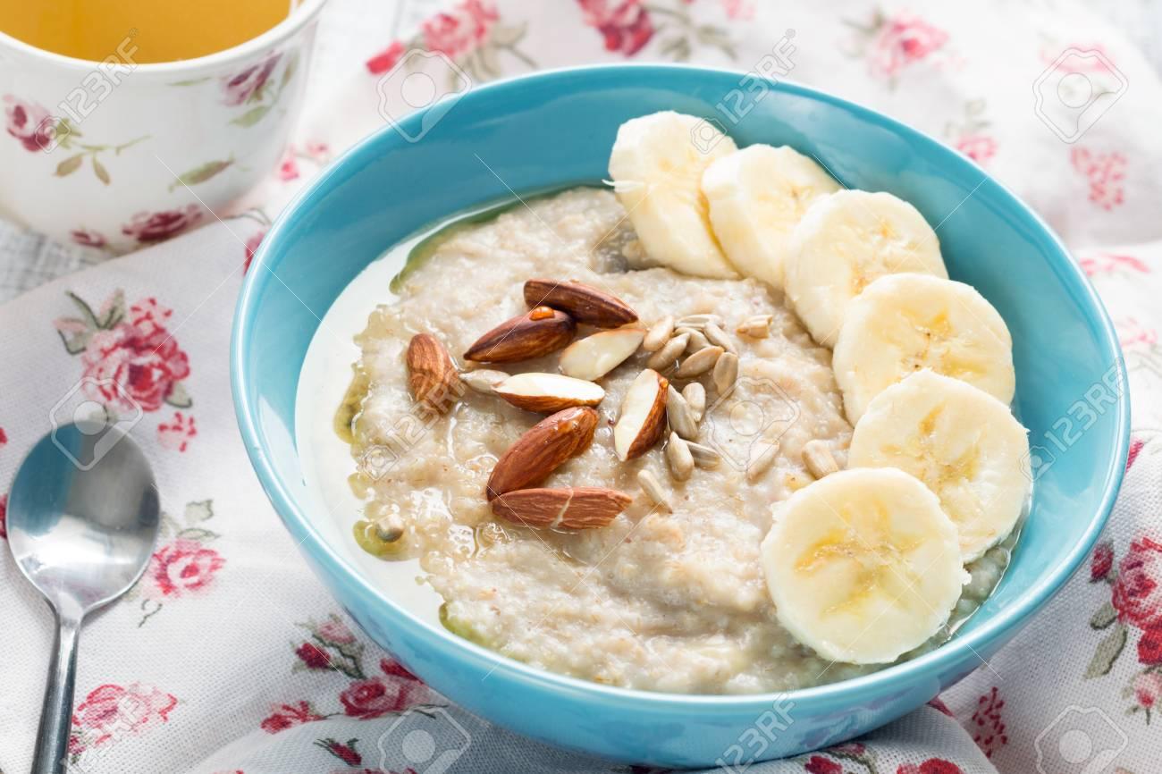 Best White tea cup; bowl of oatmeal porridge on tablecloth