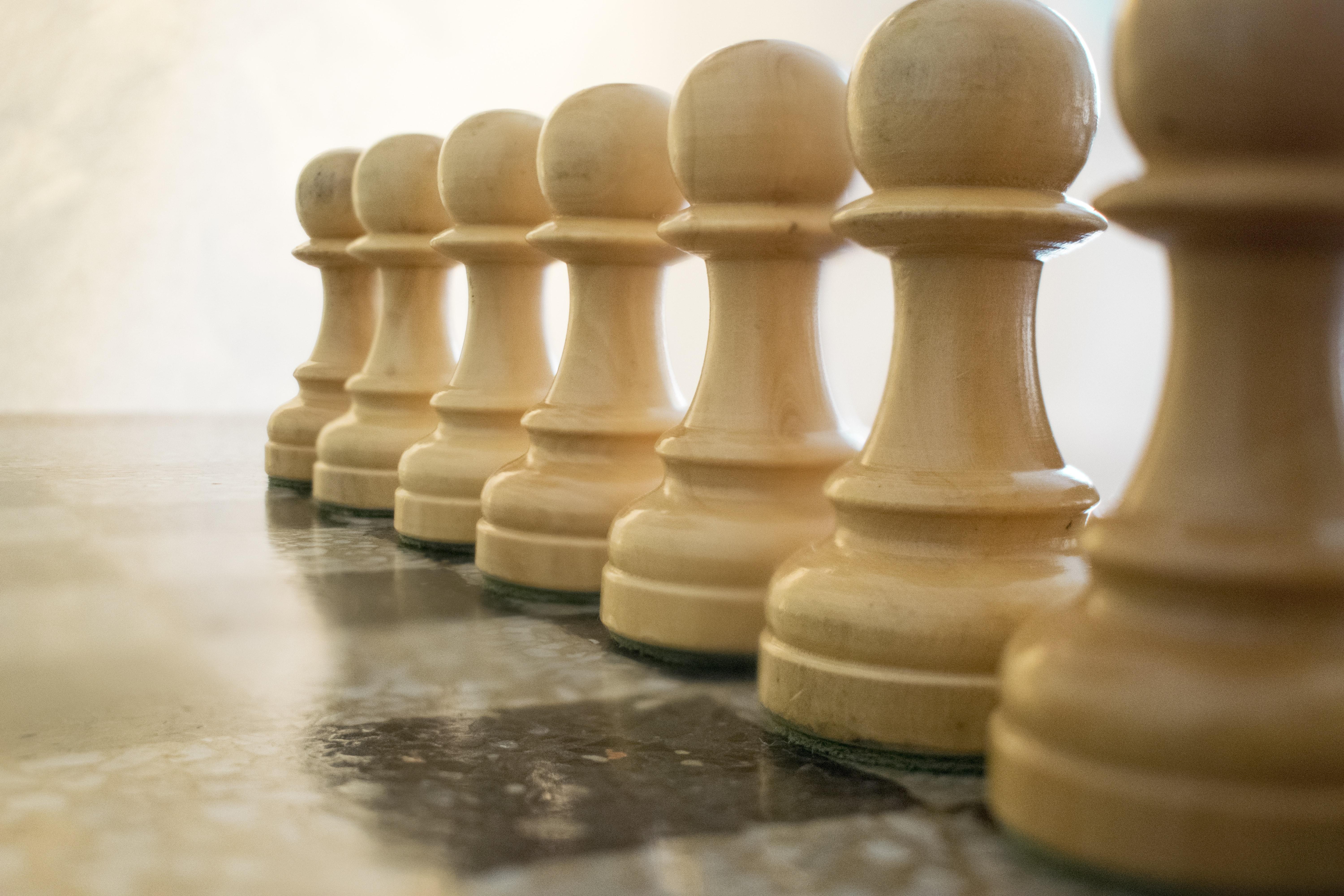 seven brown wooden pawn chess pieces free image