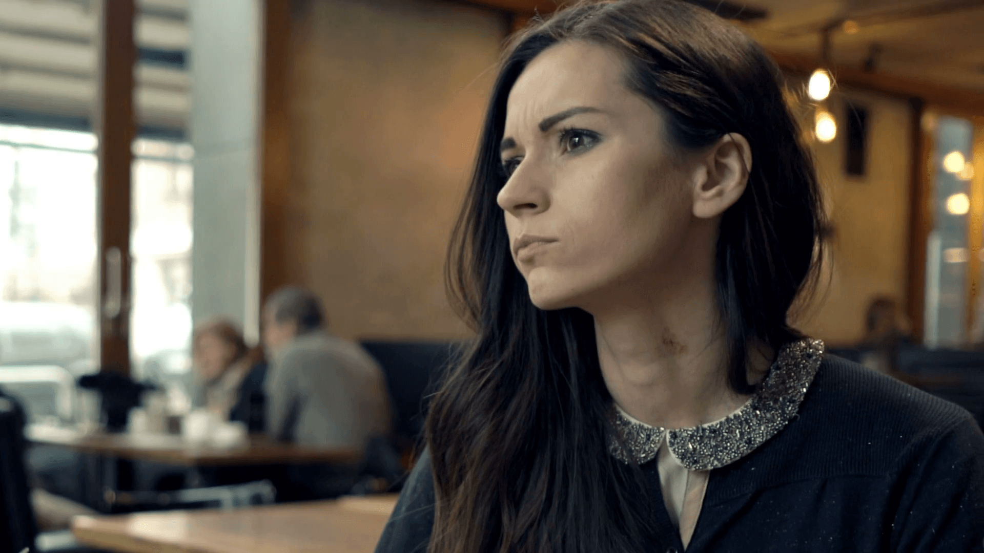 Worried woman looking around and waiting for someone in cafe Stock Video Footage