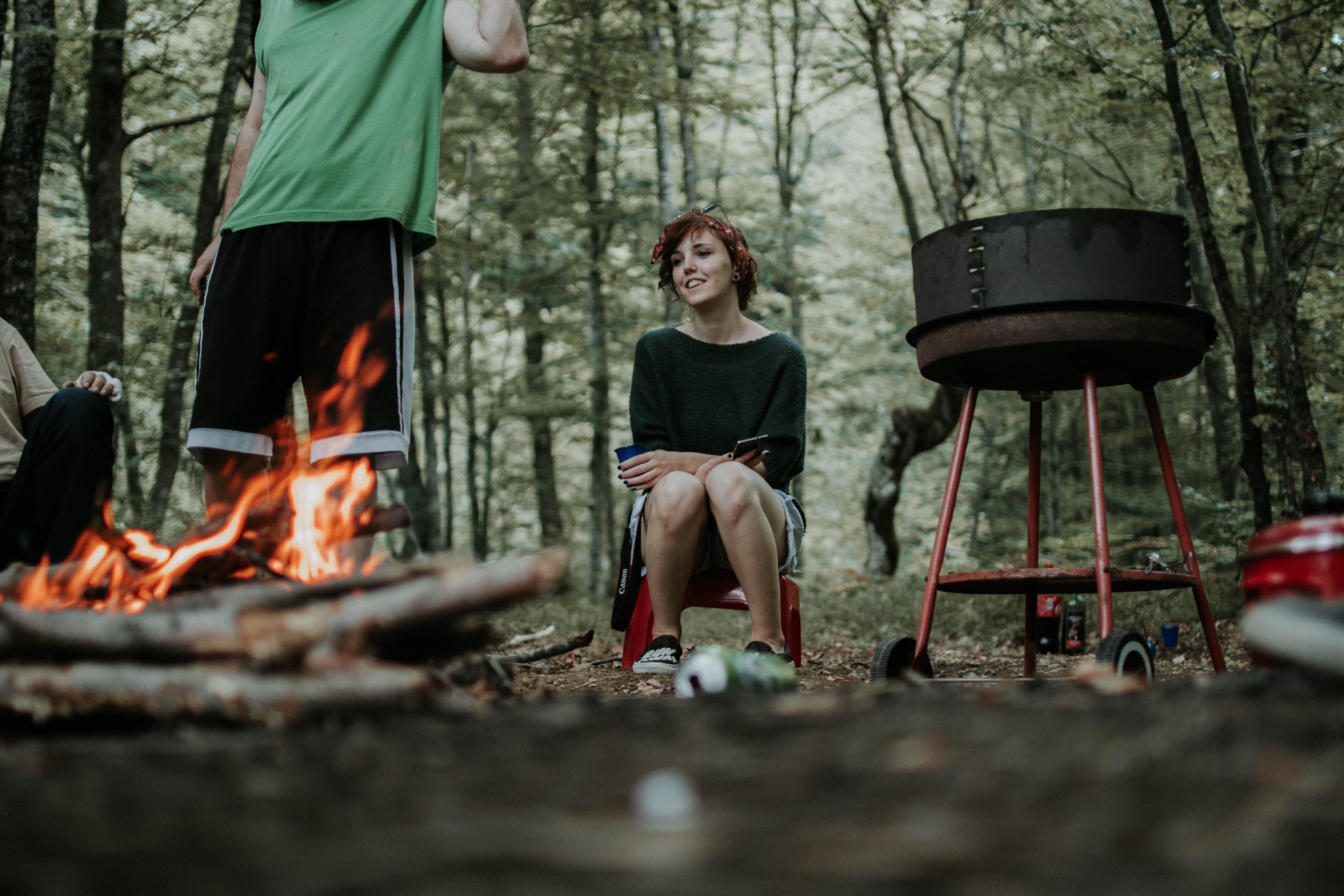 Man And Woman Gathering Around A Bonfire
