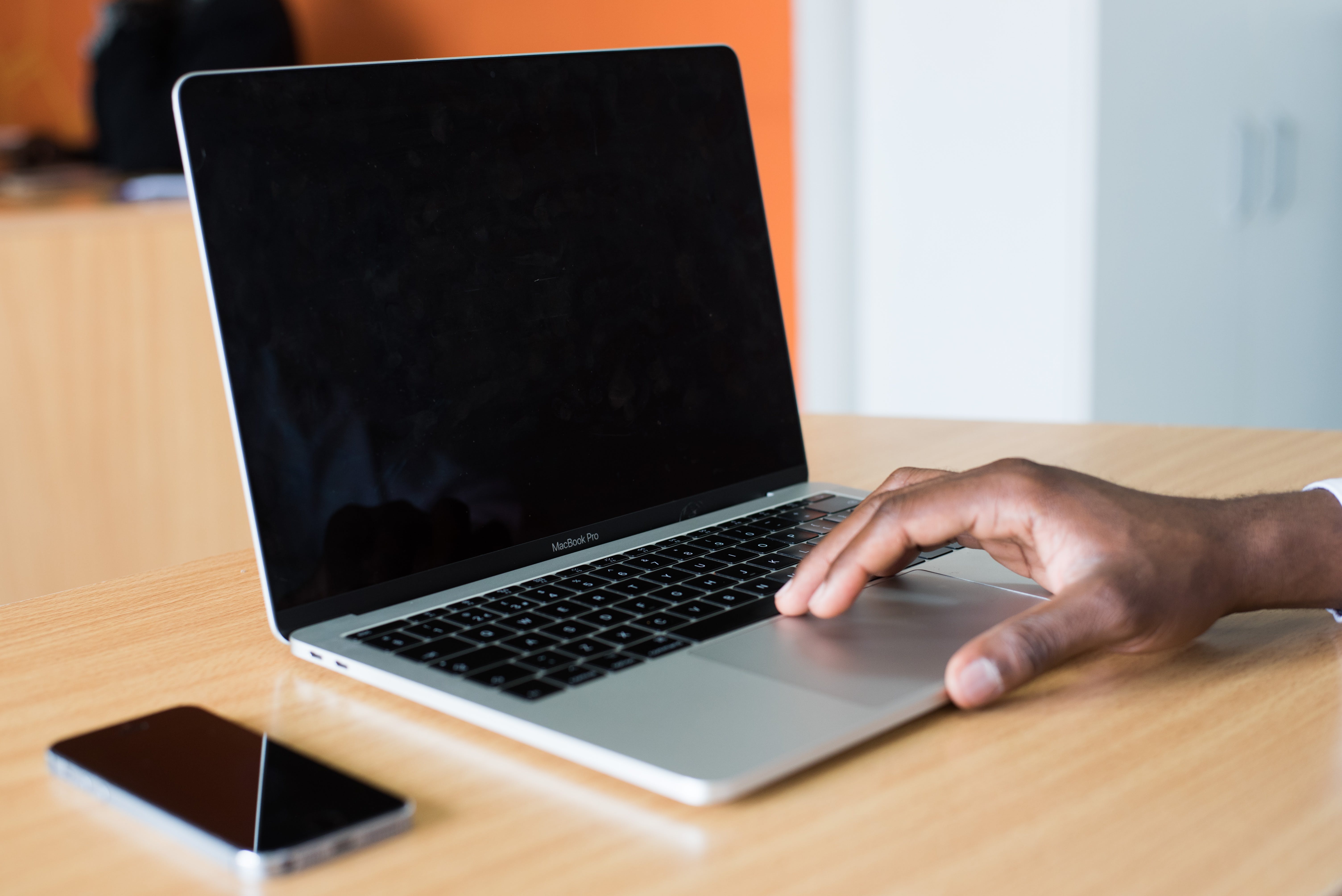 Person's Hand On Macbook Pro Image