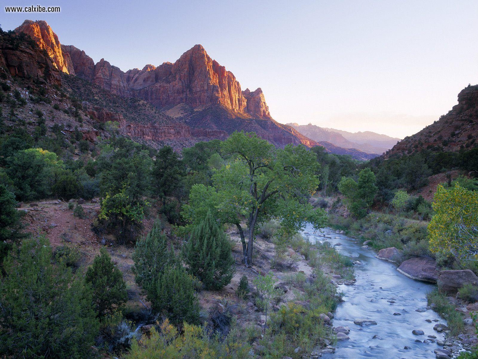 Nature: The Watchman Towers Over The Virgin River At Sunset