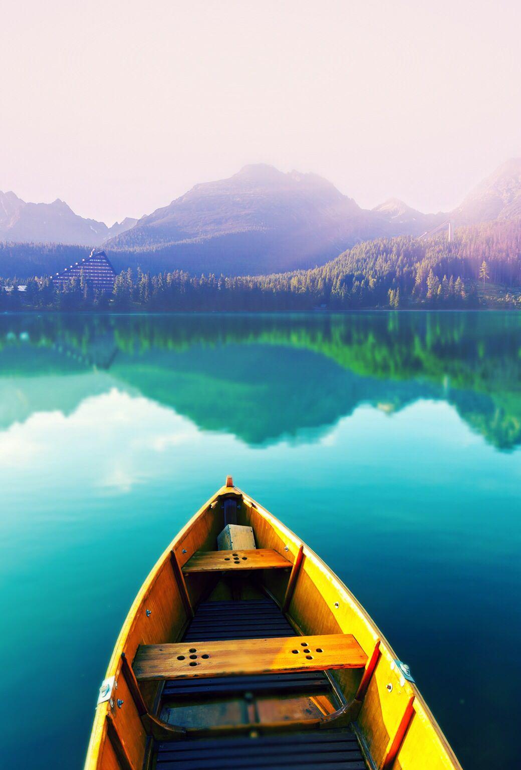 Rowboat in blue water & mountains. Boat wallpaper, Best iphone