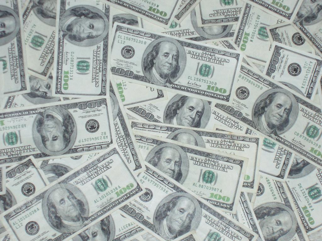 Ben Franklins - $100 bills no. 001. a pile of $100 bills Th