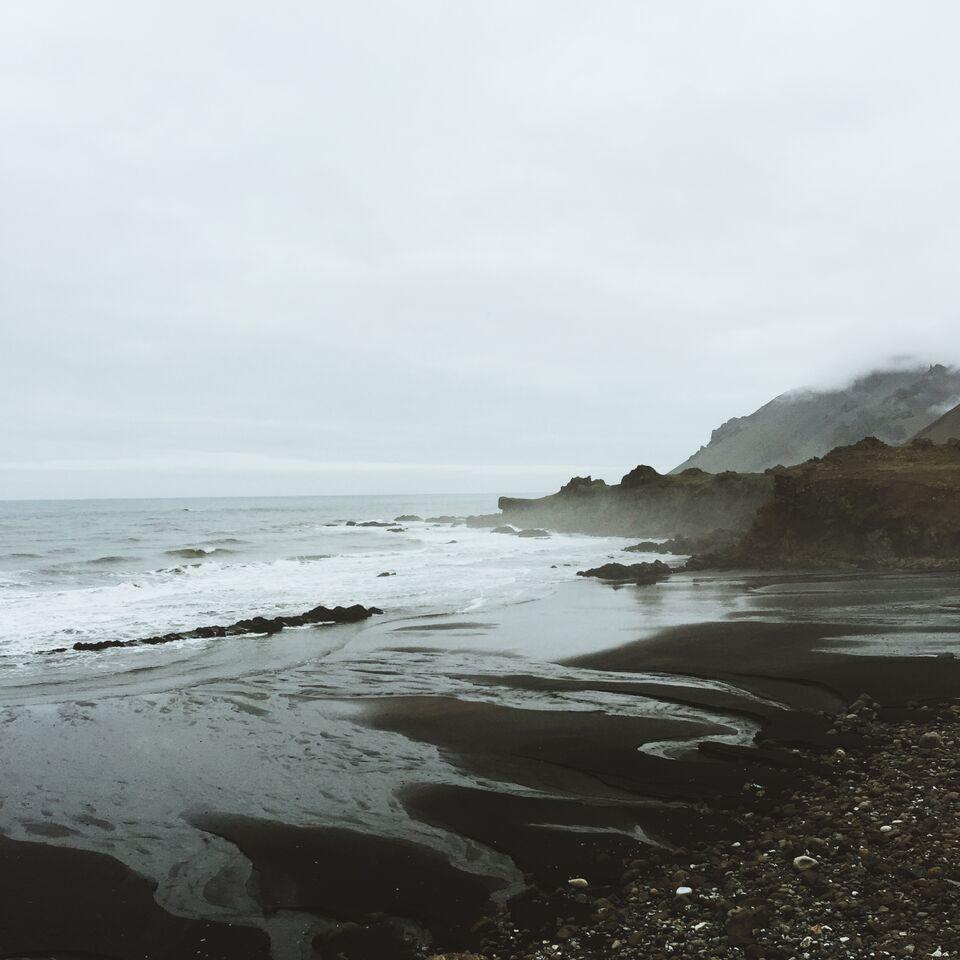 Cold and Foggy Black Sand Beach Cliff Shore Line