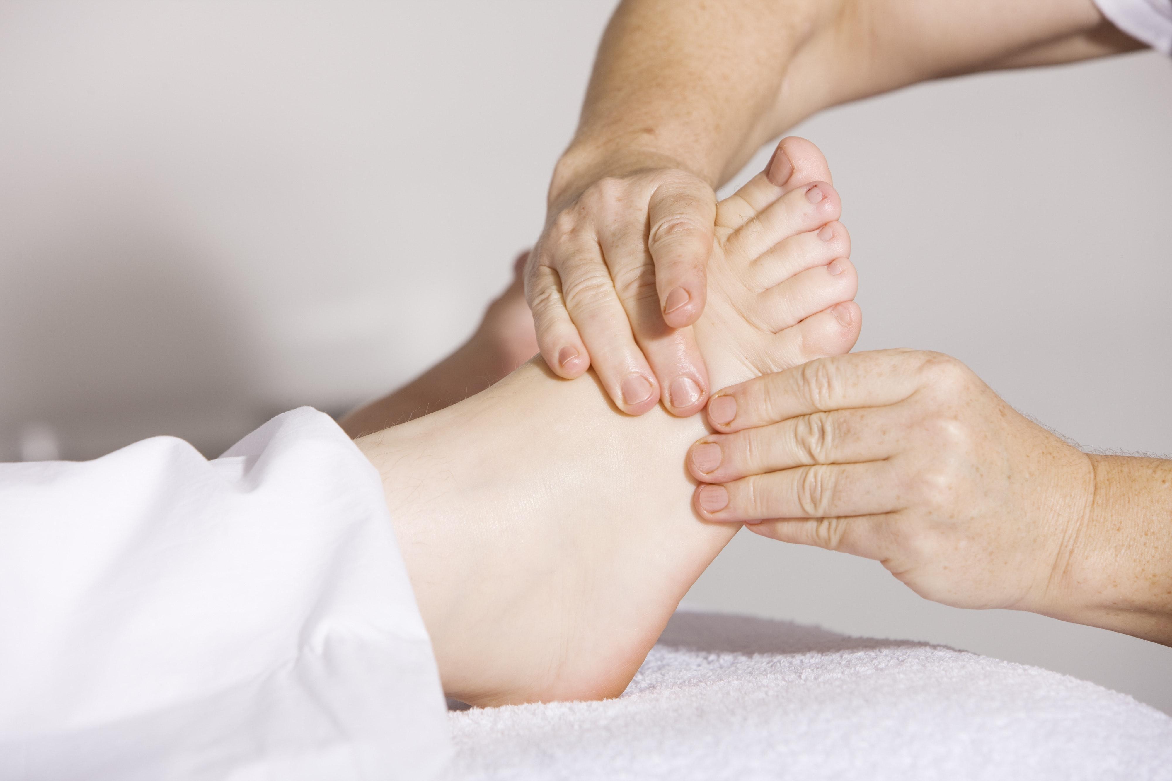 Person Massaging Foot · Free