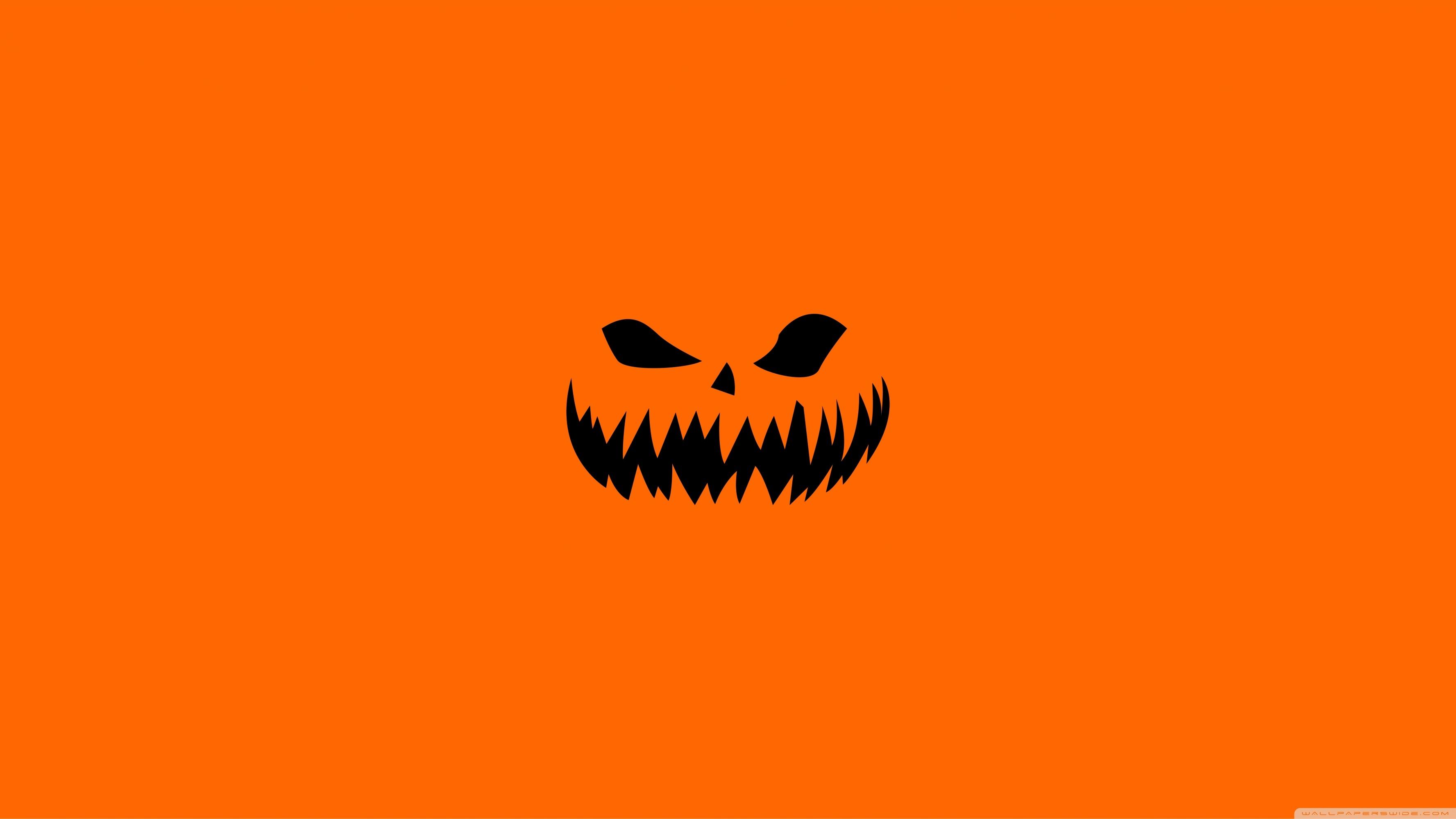 Scary Halloween Face on Orange Background Wallpaper