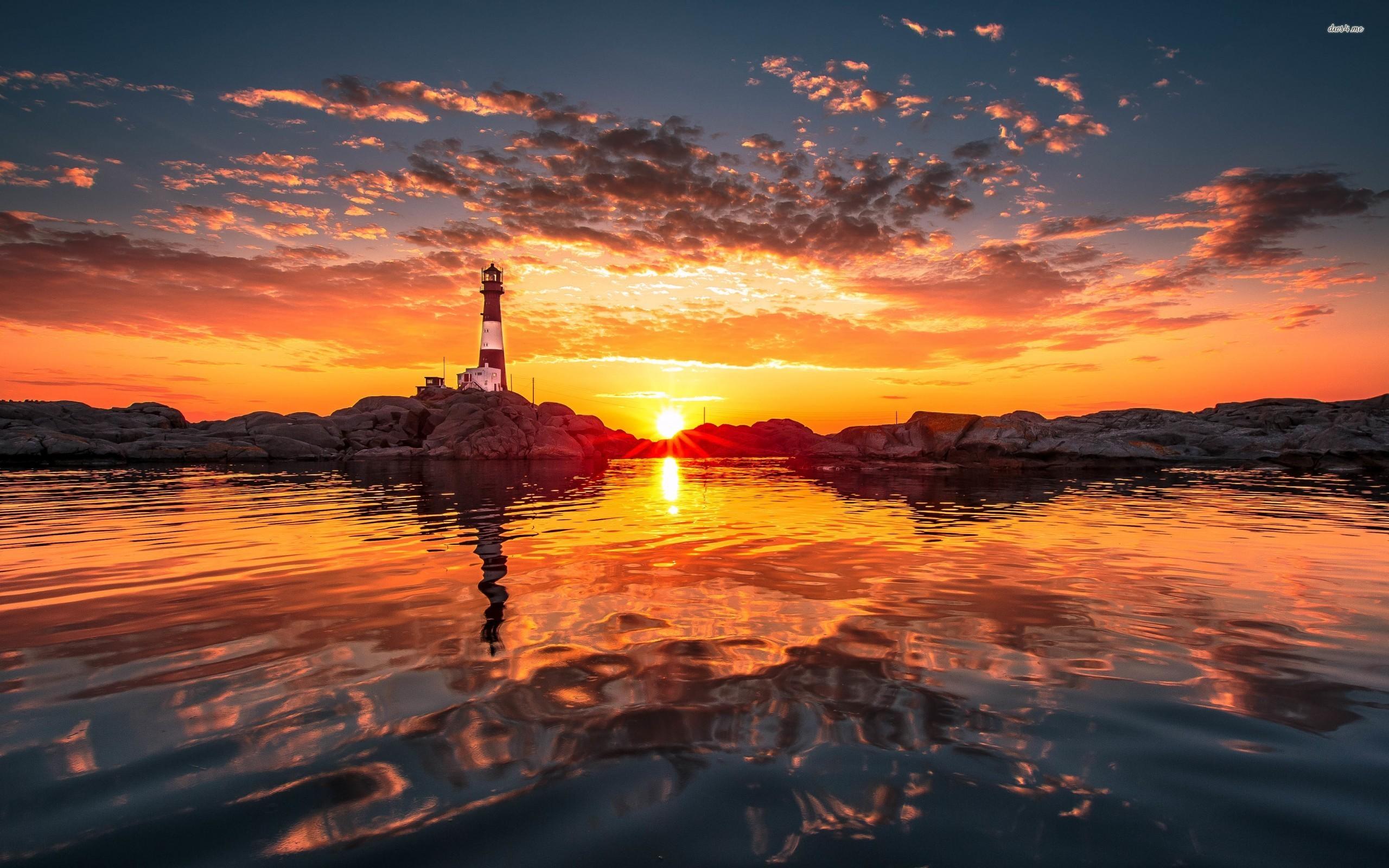 Beautiful sunset by the lighthouse wallpaper