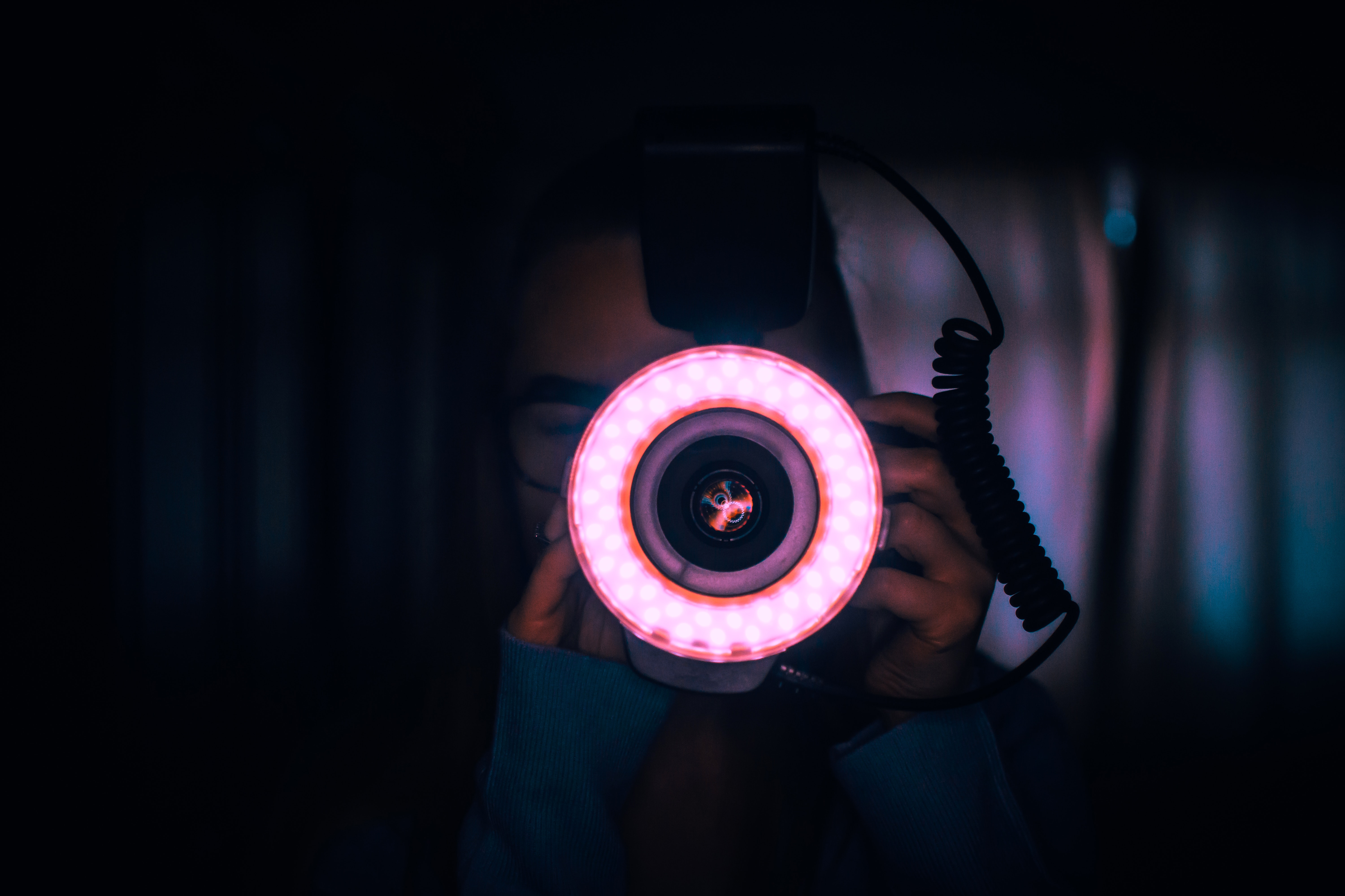 Person Holding Camera With Red Lights on Lens · Free