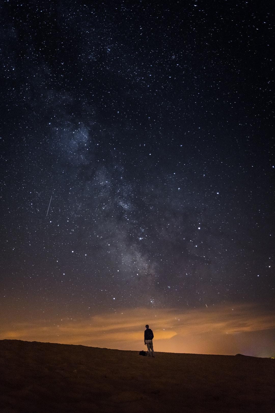 person looking at the milkyway photo