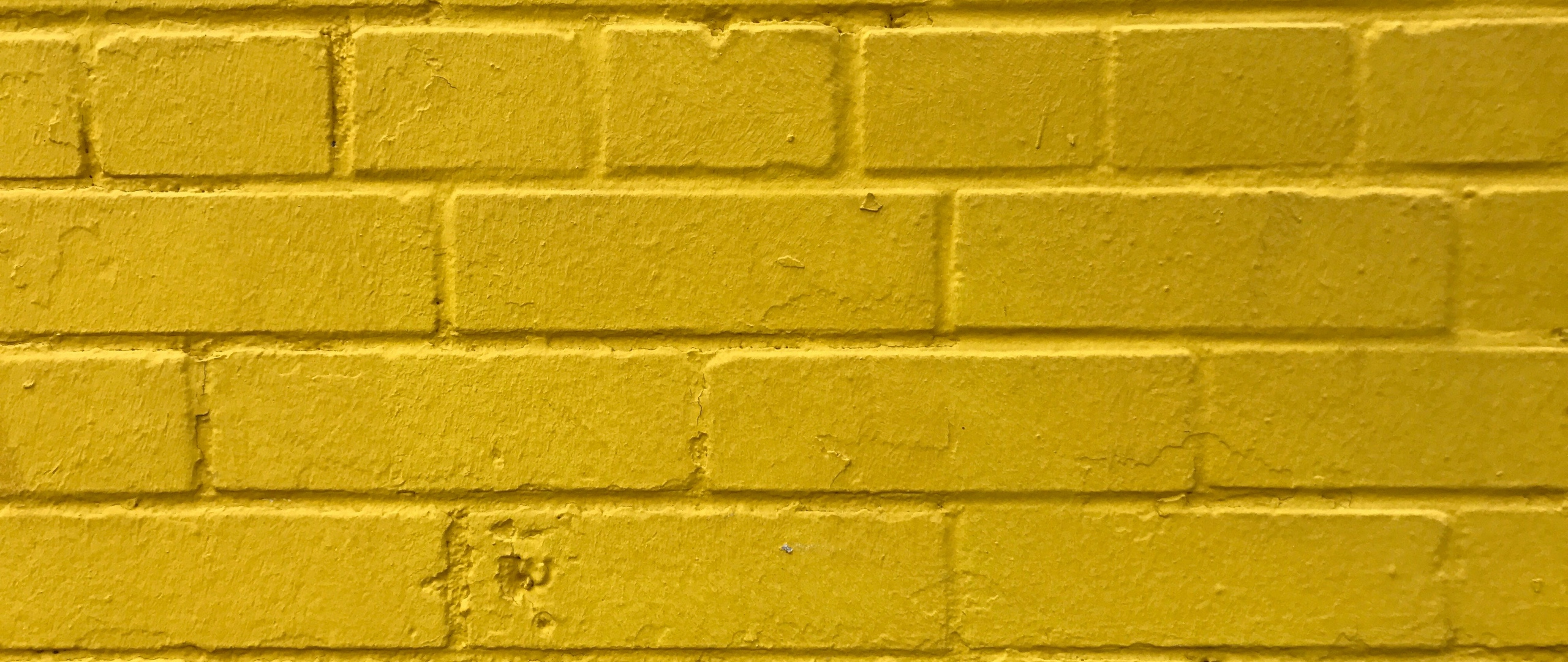 Download wallpaper 2560x1080 bricks, yellow, wall, texture
