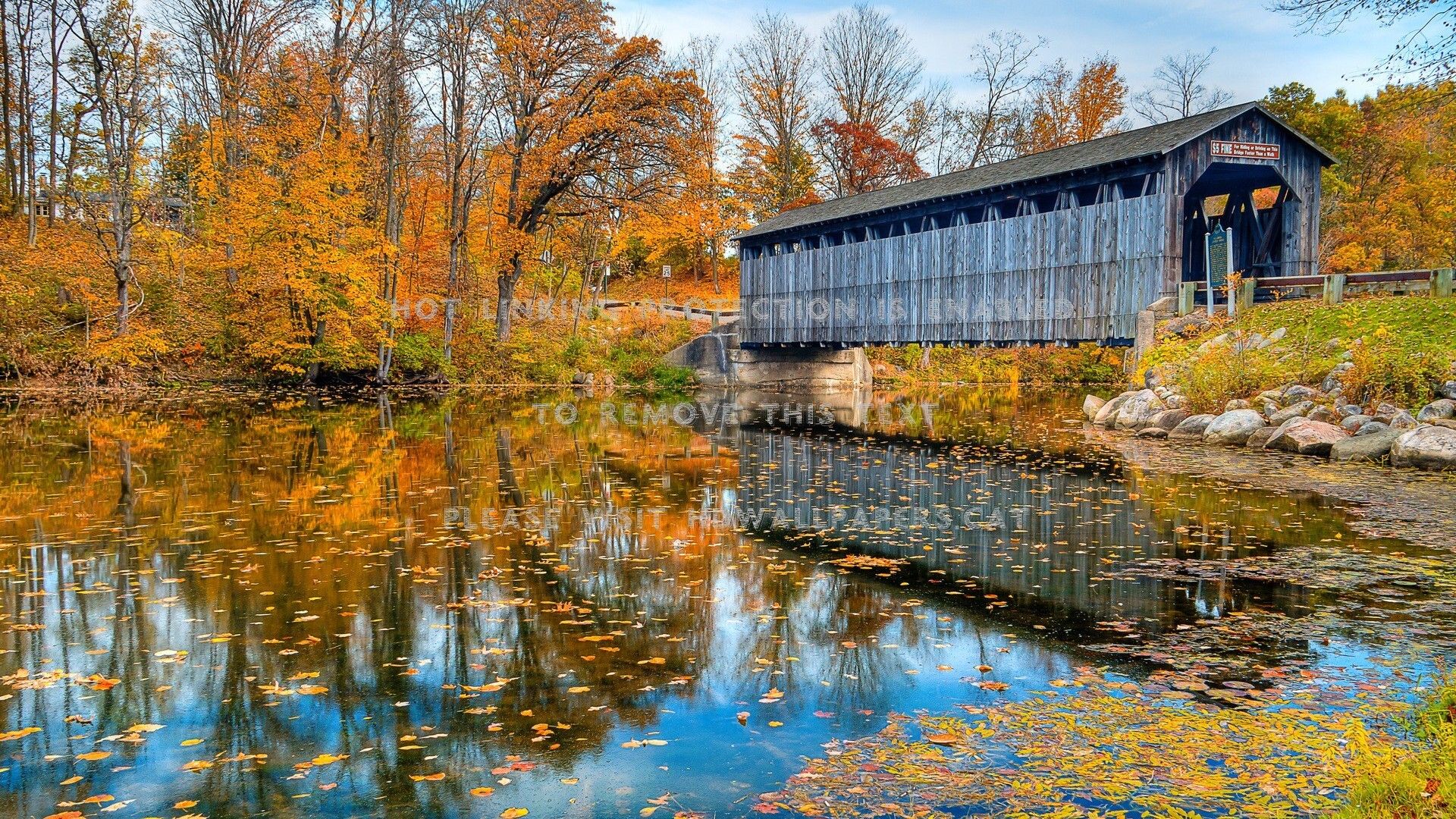 covered bridge in autumn lake reflection