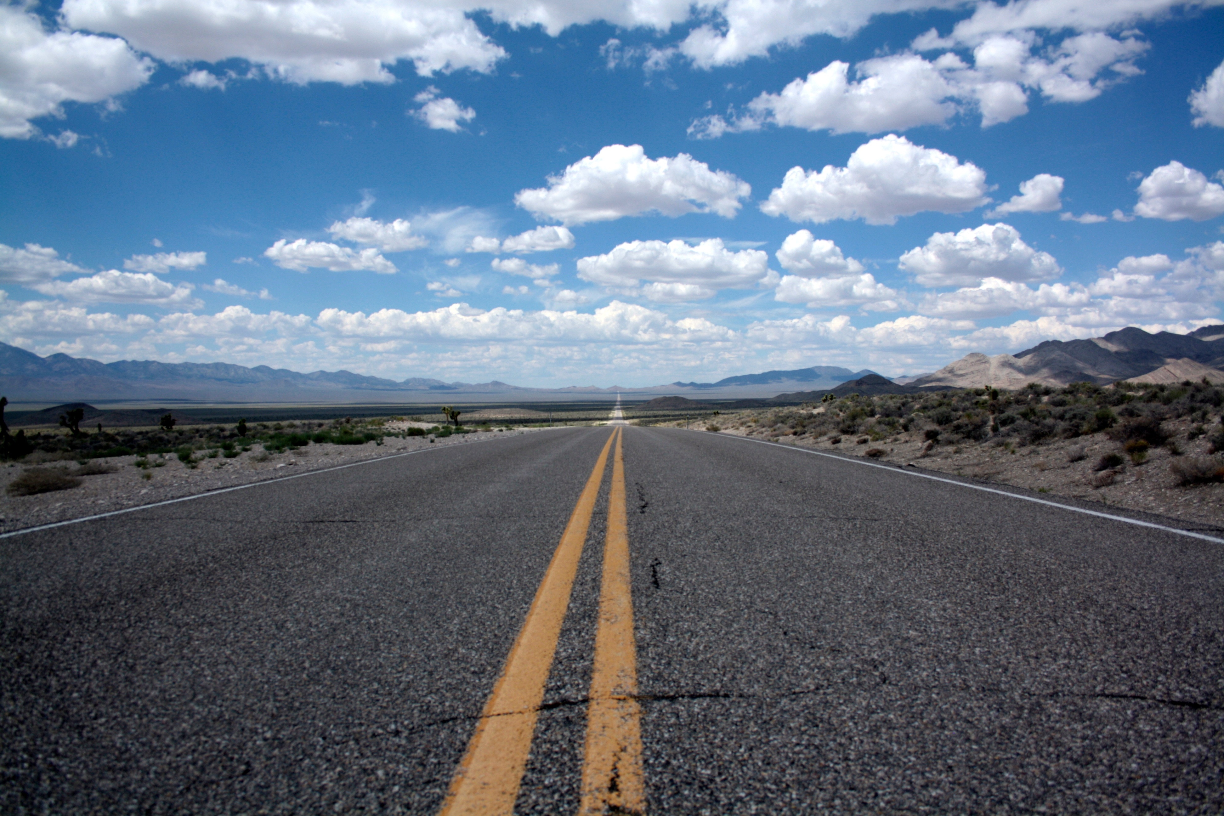 brown concrete road under blue cloudy sky free image