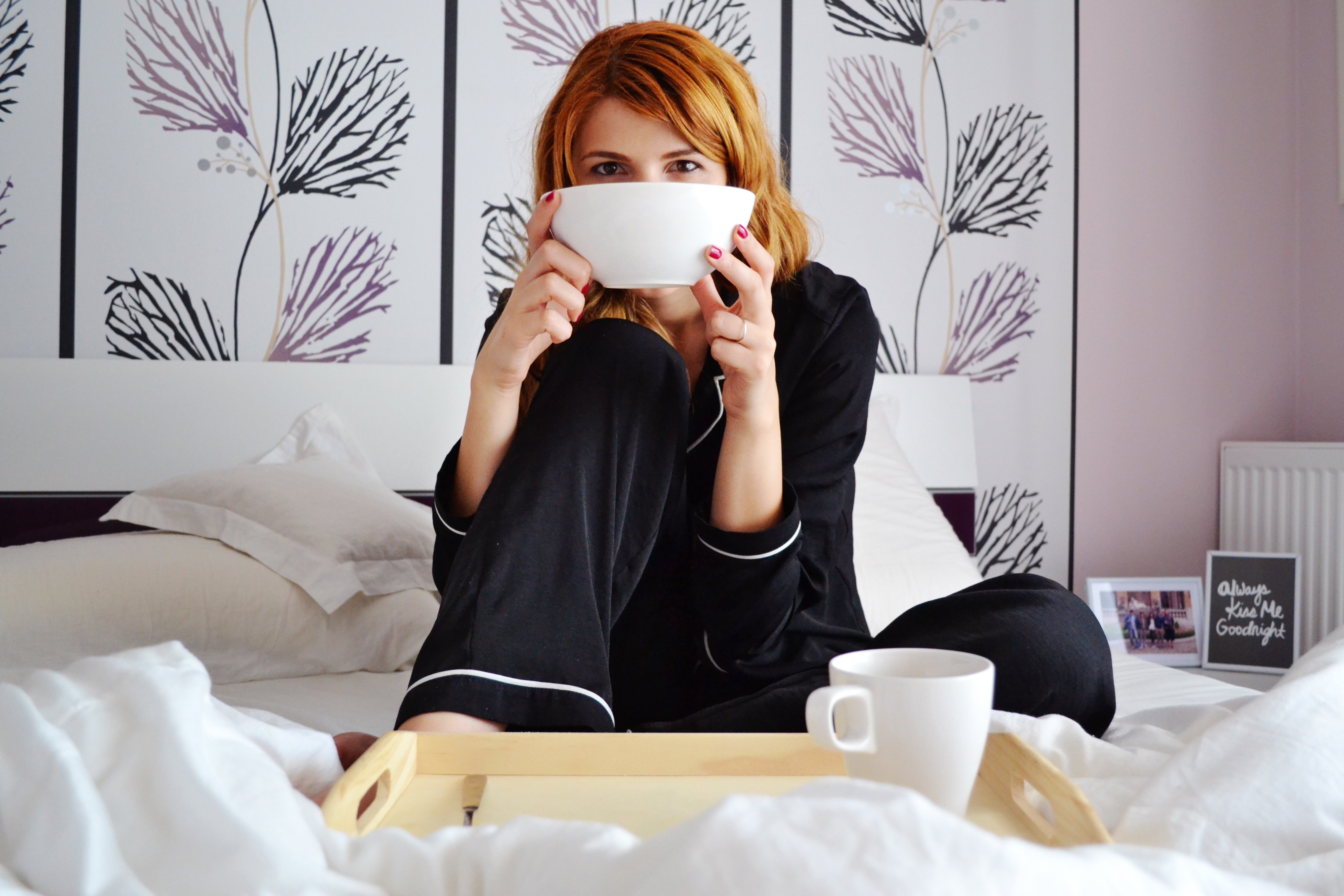 Woman in Pajamas Sitting on the Bed Holding a Bowl · Free