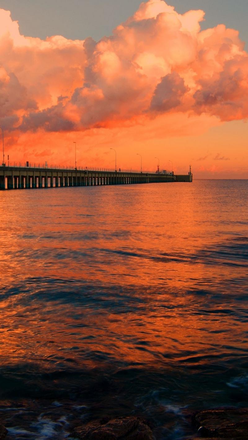 Download wallpaper 800x1420 dock, pier, sea, sunset iphone