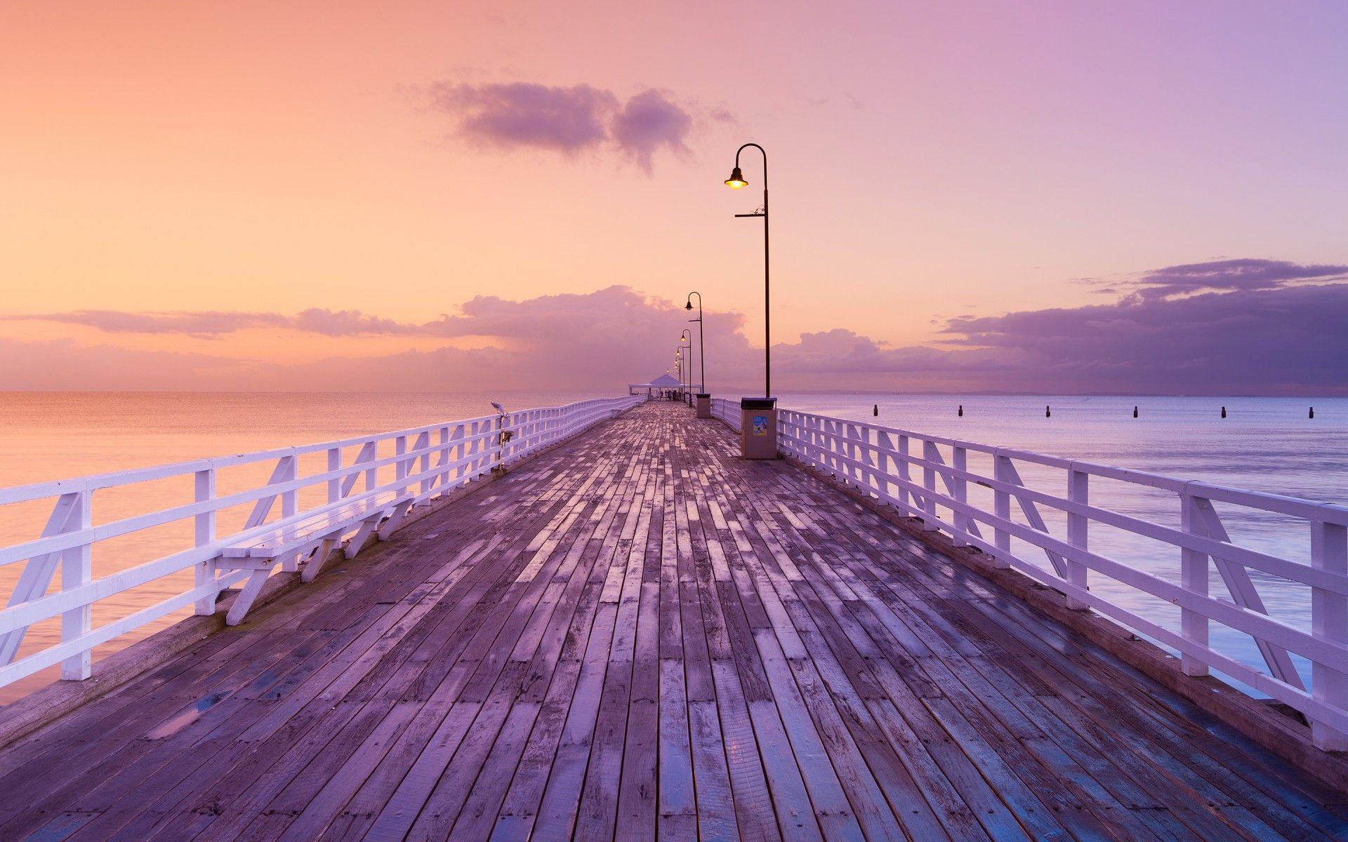 dock pier sunset sunrise ocean sky clouds