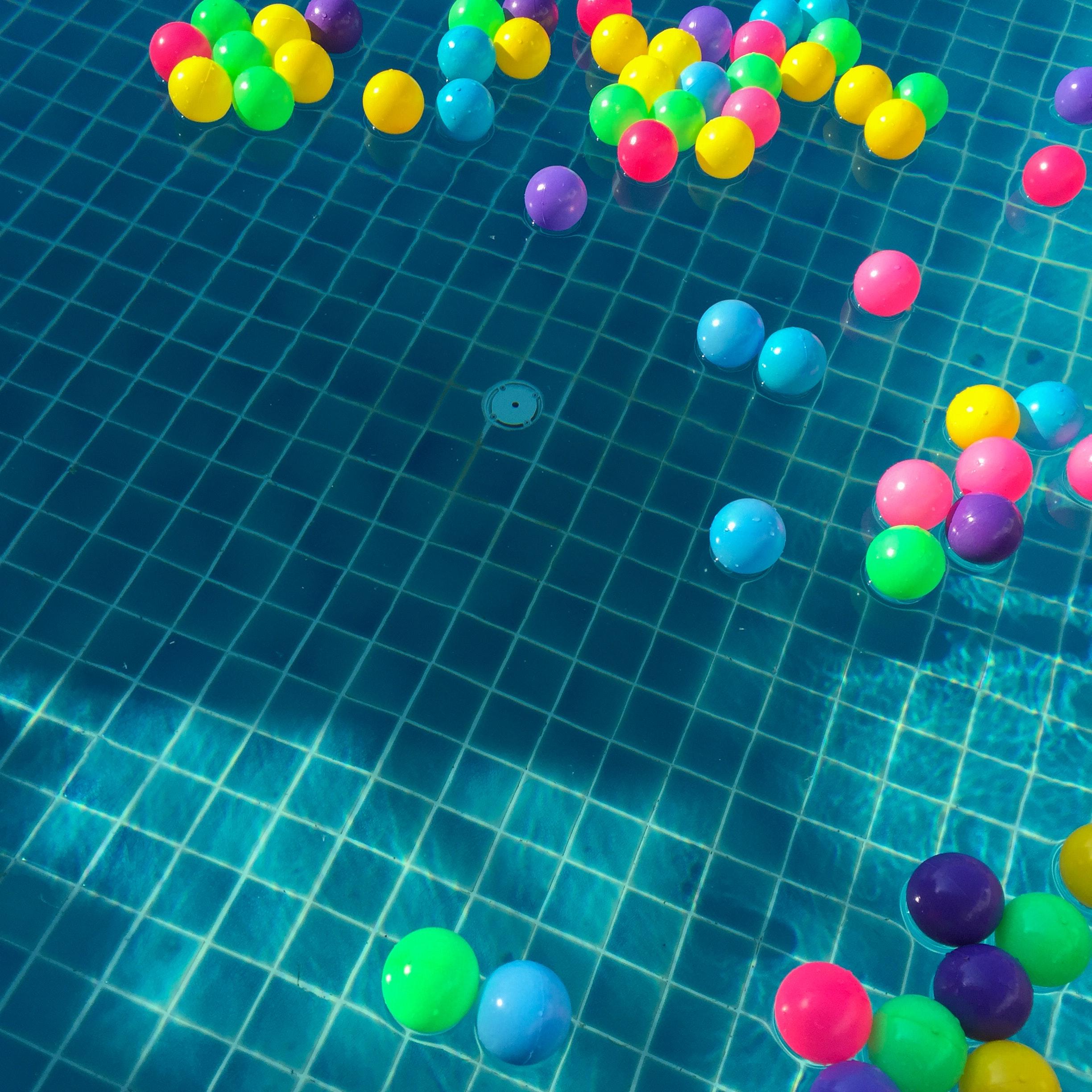 Assorted Color Balls Floating On Water · Free