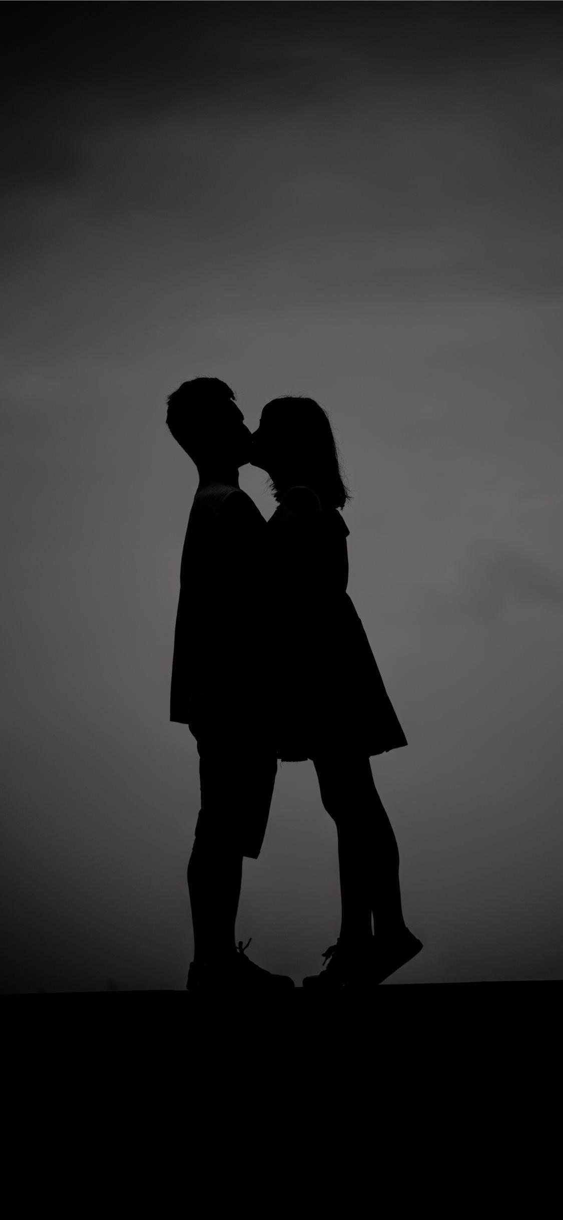 A pair of lovers who are kissing iPhone X Wallpaper Free Download