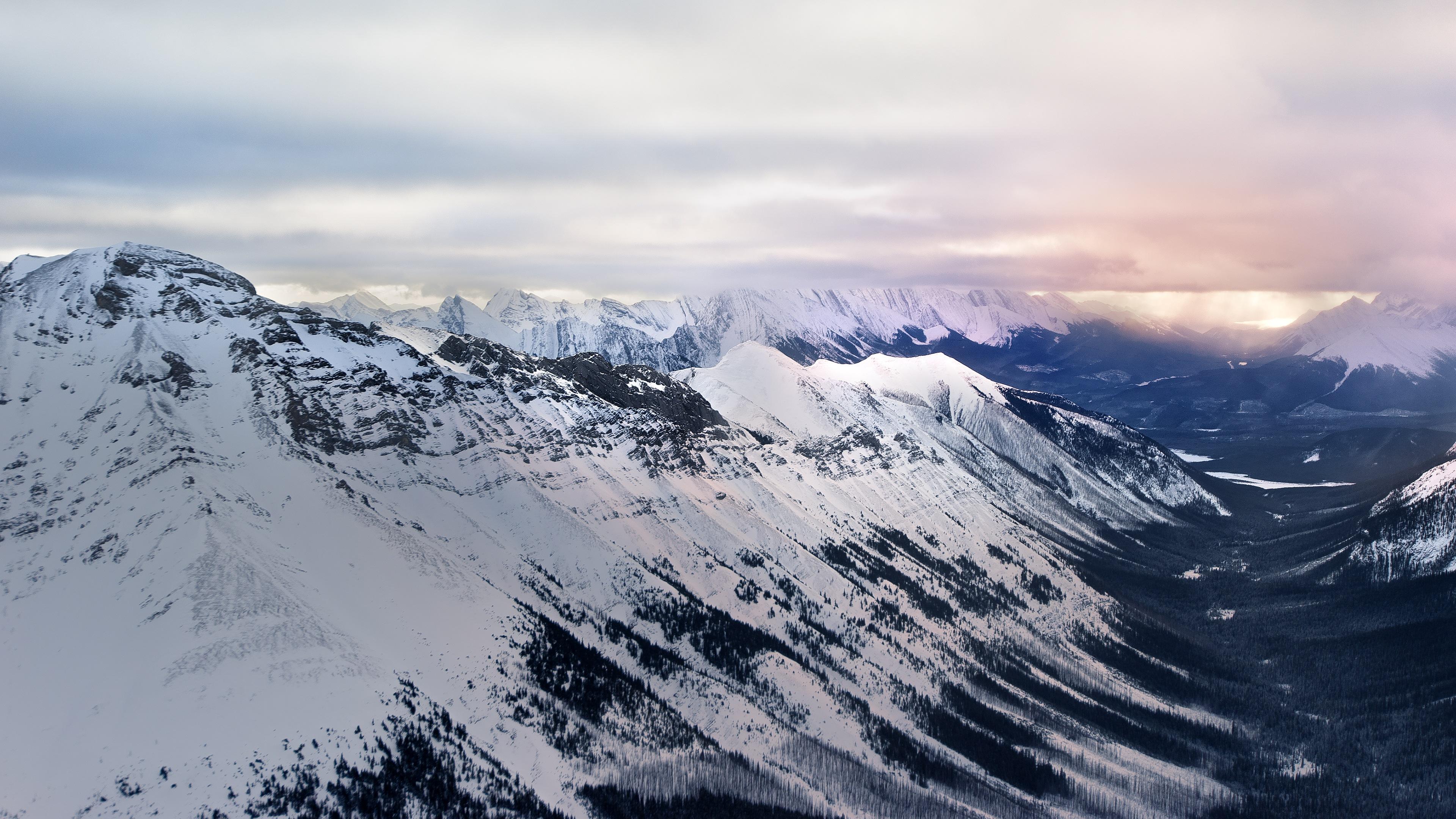 Snowy Mountain Range Distant Storm 4K Desktop Wallpaper