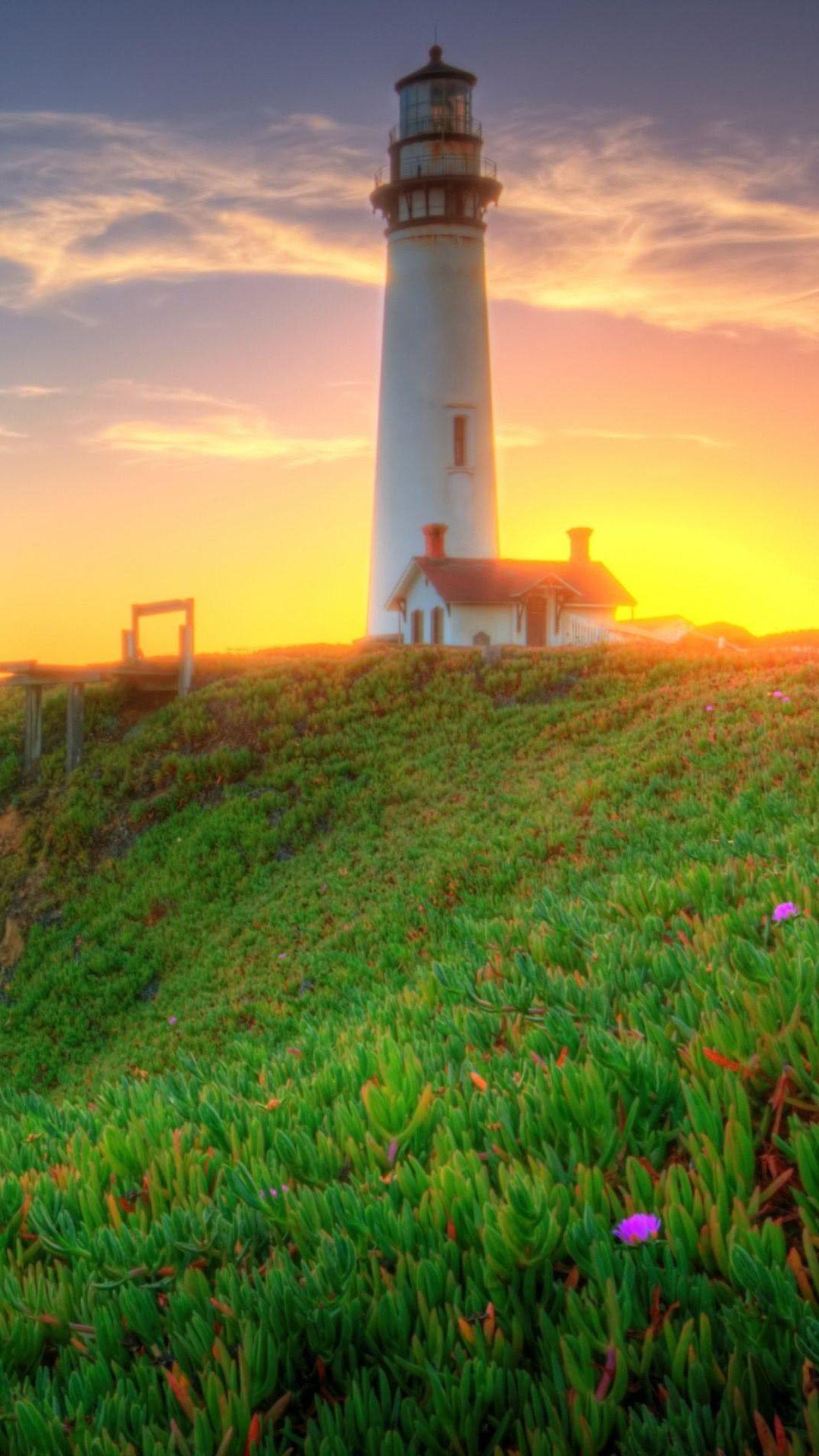 Lighthouse On Green Coast Android Wallpaper free download