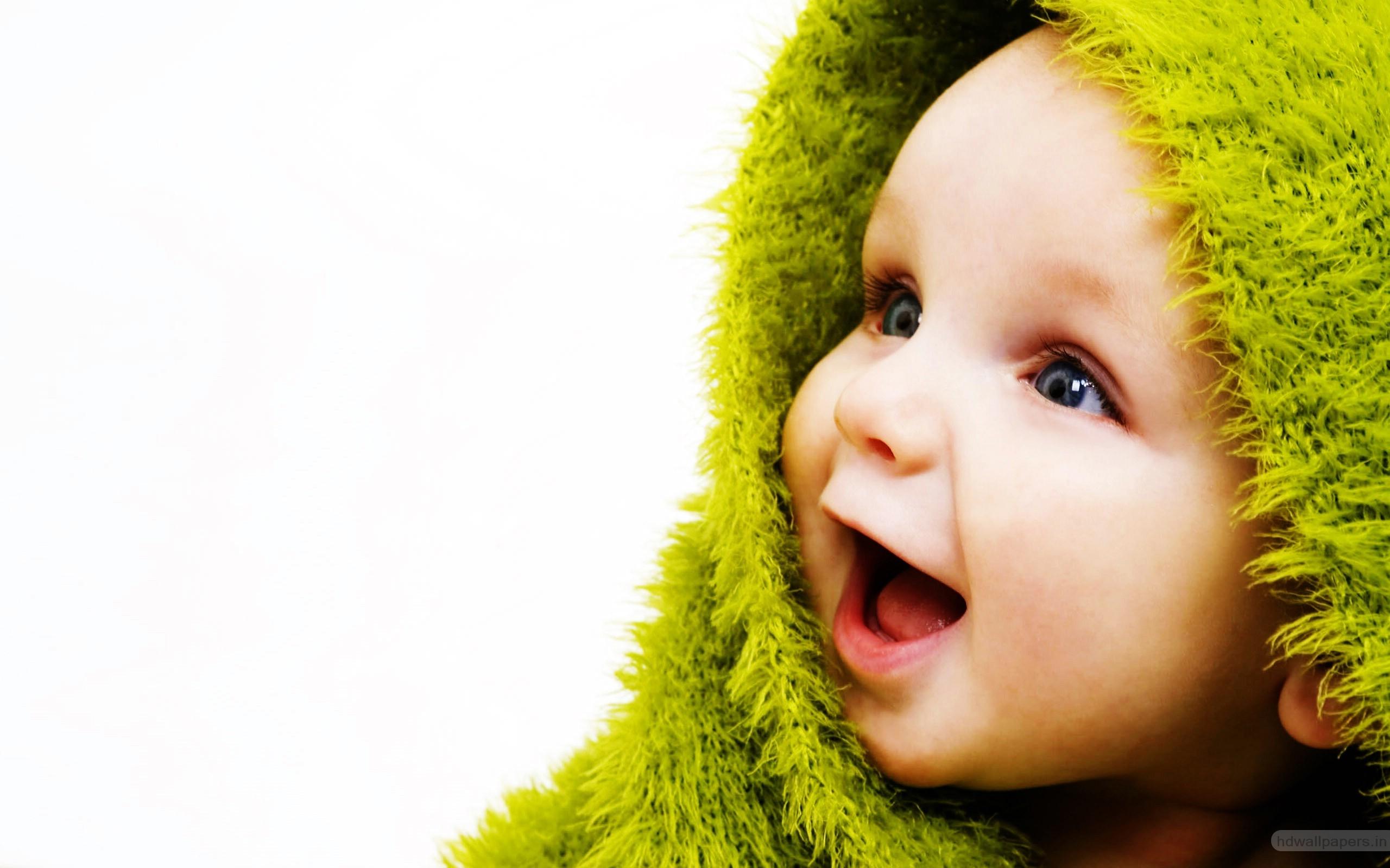 Cute Small Baby with Smile in Green Wallpaper