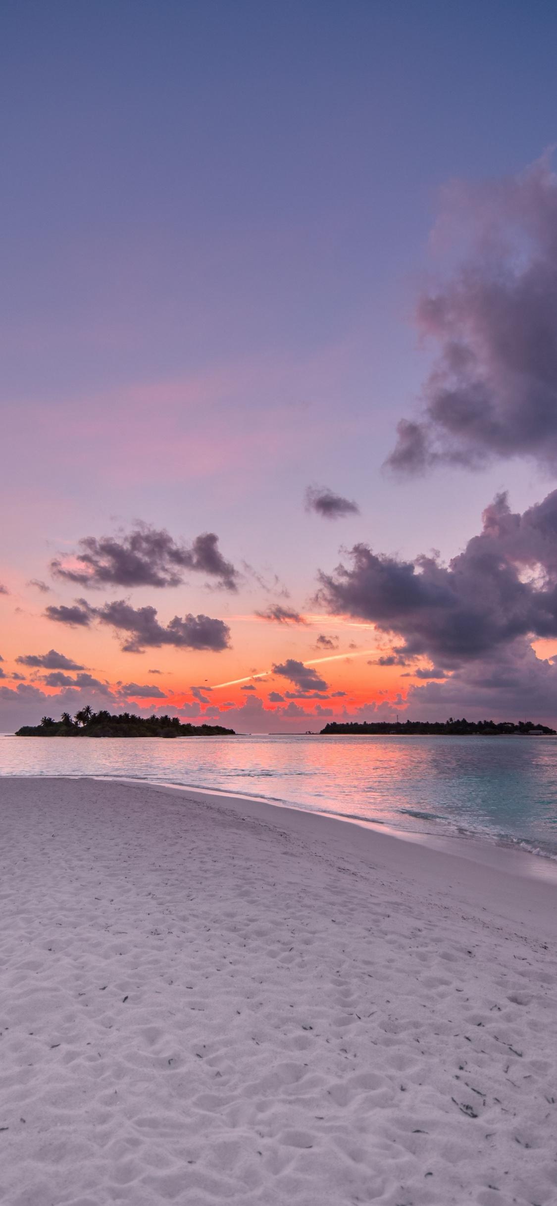 Download 1125x2436 wallpaper beach, island, sunset, clouds