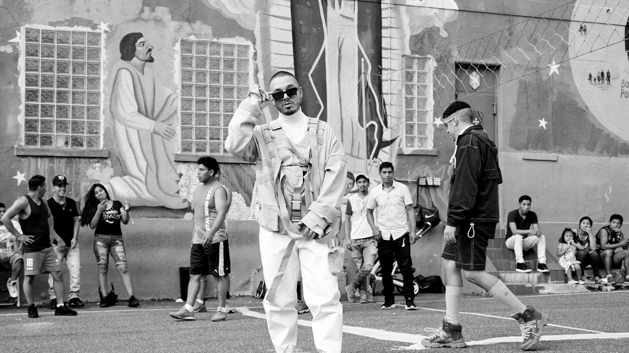J Balvin & Bad Bunny Standing In Front Of A Religious