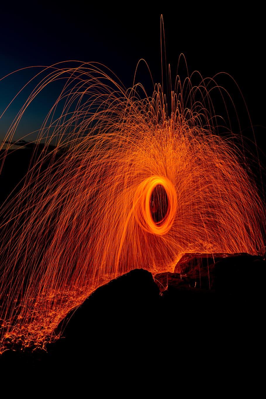 HD wallpaper: person taking photo of round steel wool, spark