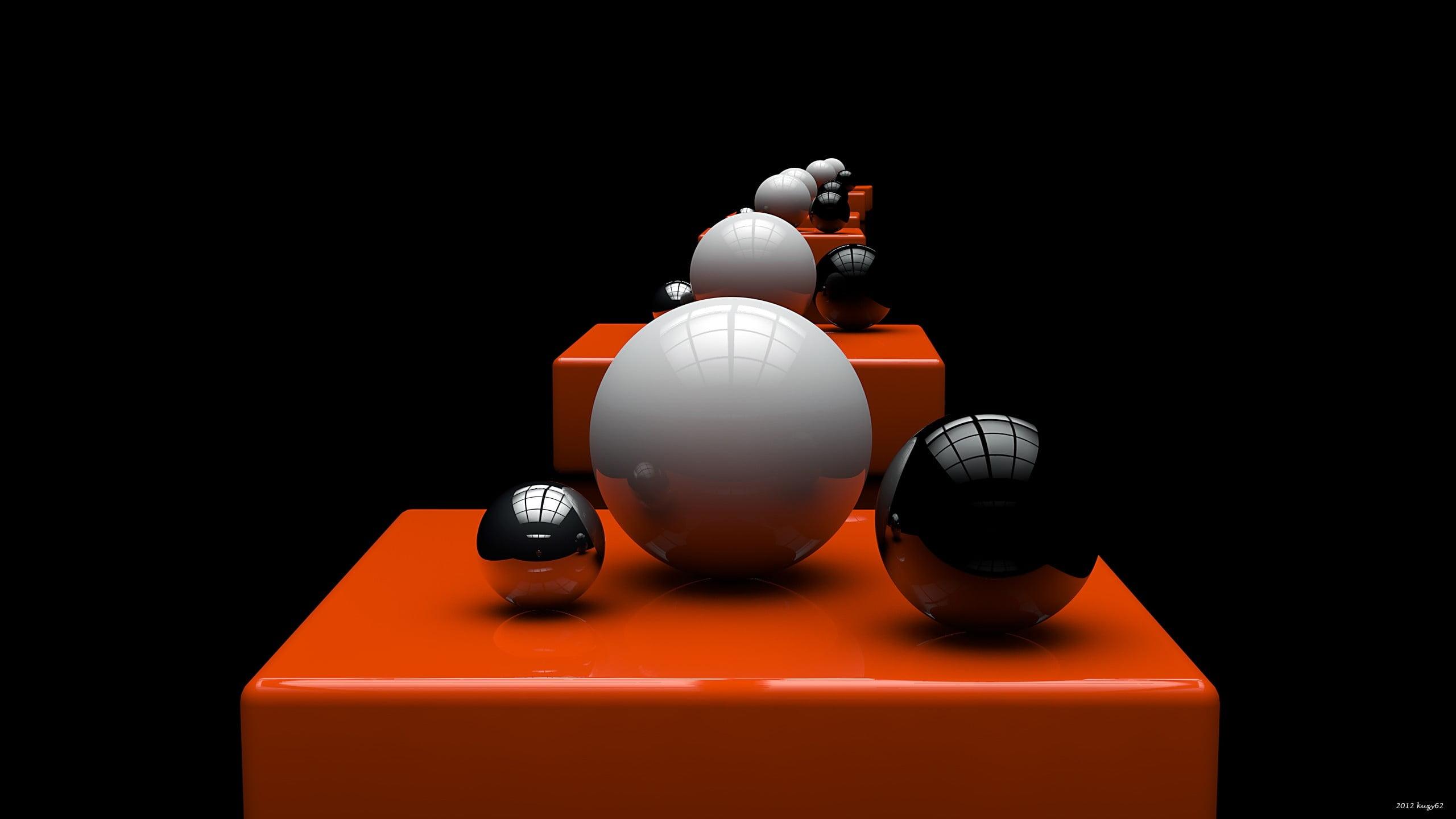 Two black and one white balls on orange platform optical