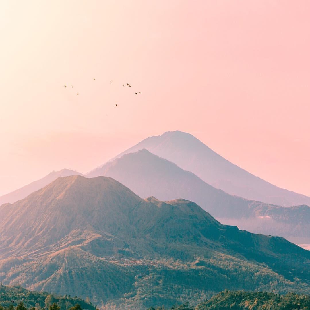 Pastel pink skies high above the Mountains of Bali