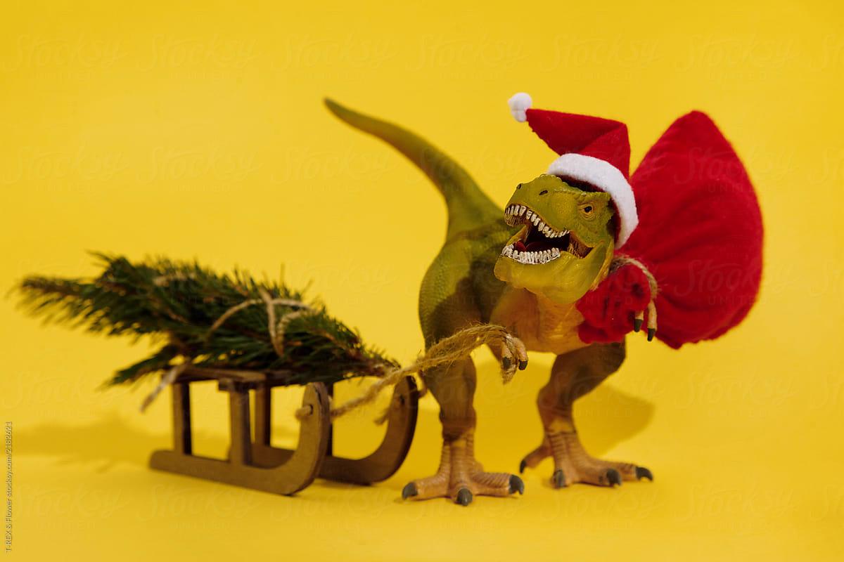 Christmas dinosaur with sledge and bag full of gifts