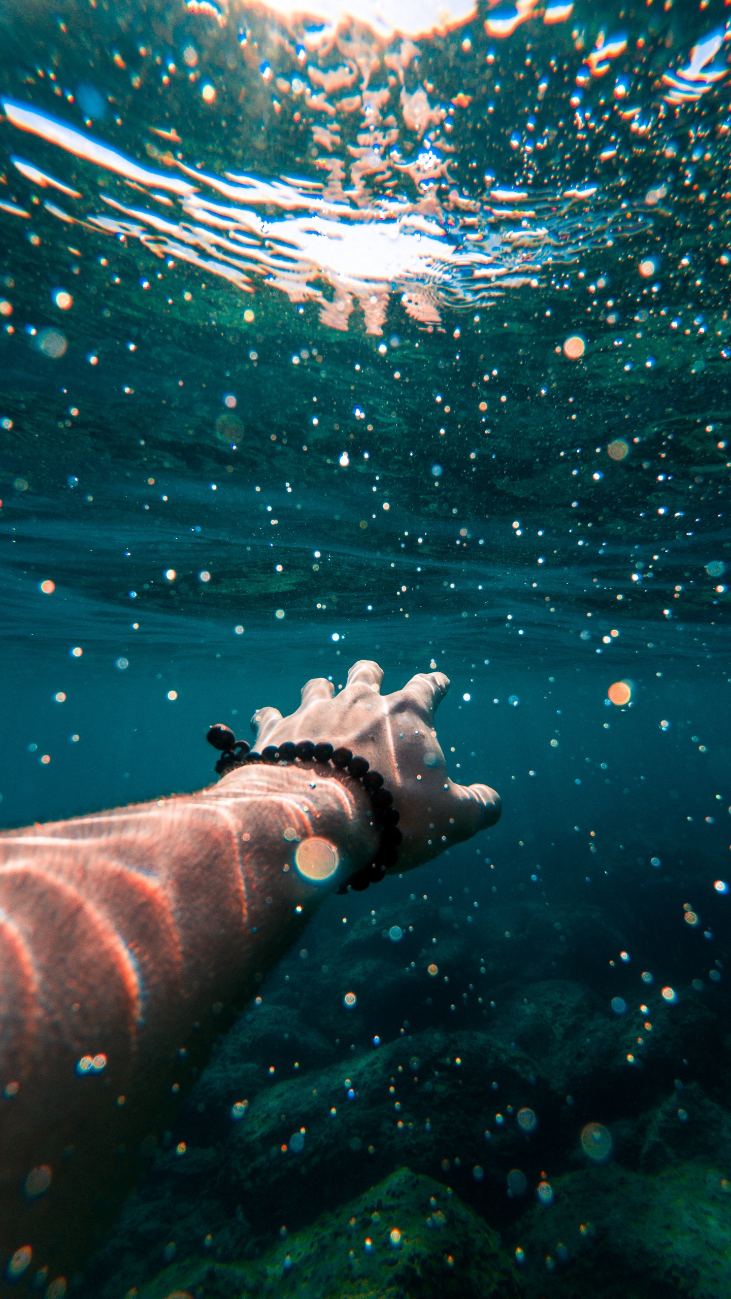 Download wallpaper 1440x2560 hand, water, swimming