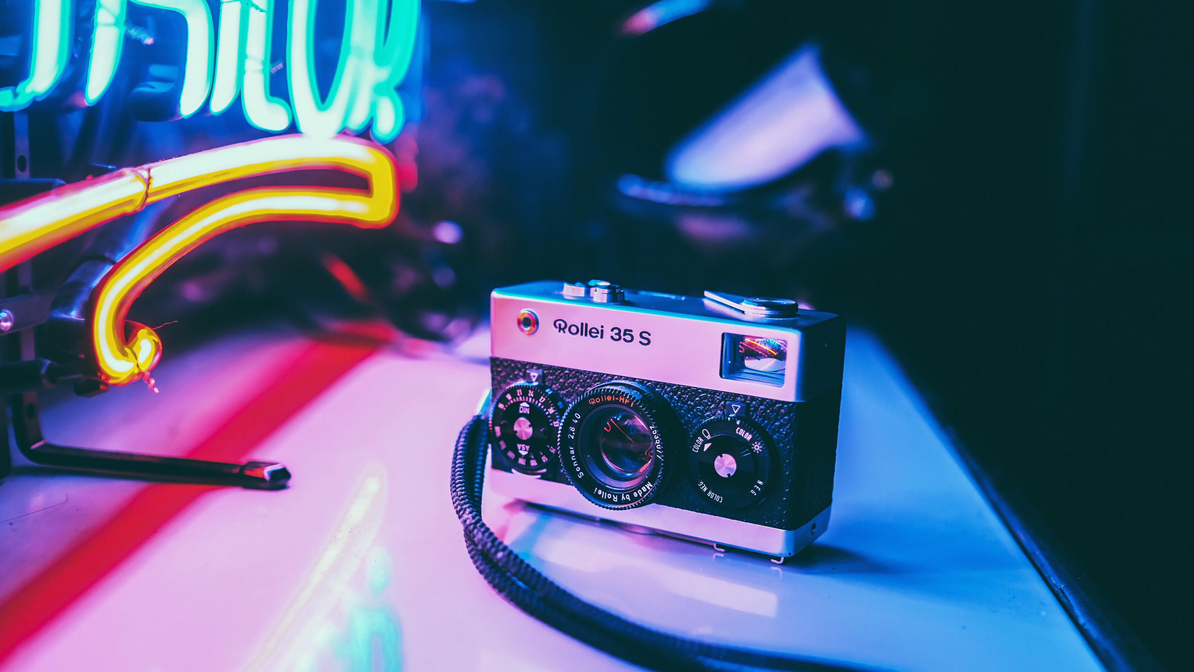 Vintage camera Rollei 35s with neon lights Wallpaper 4k Ultra HD