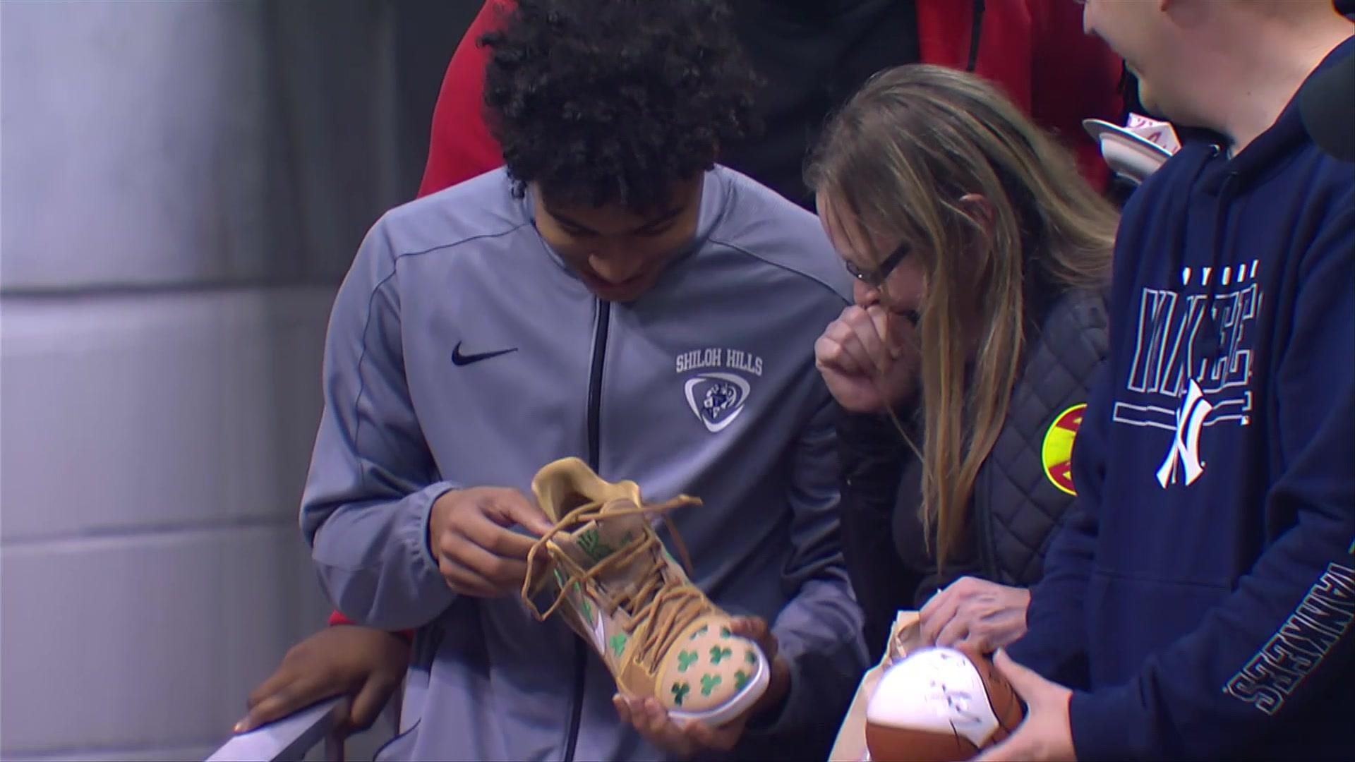 Another happy fan goes home with Kyrie Irving's shoes. NBC