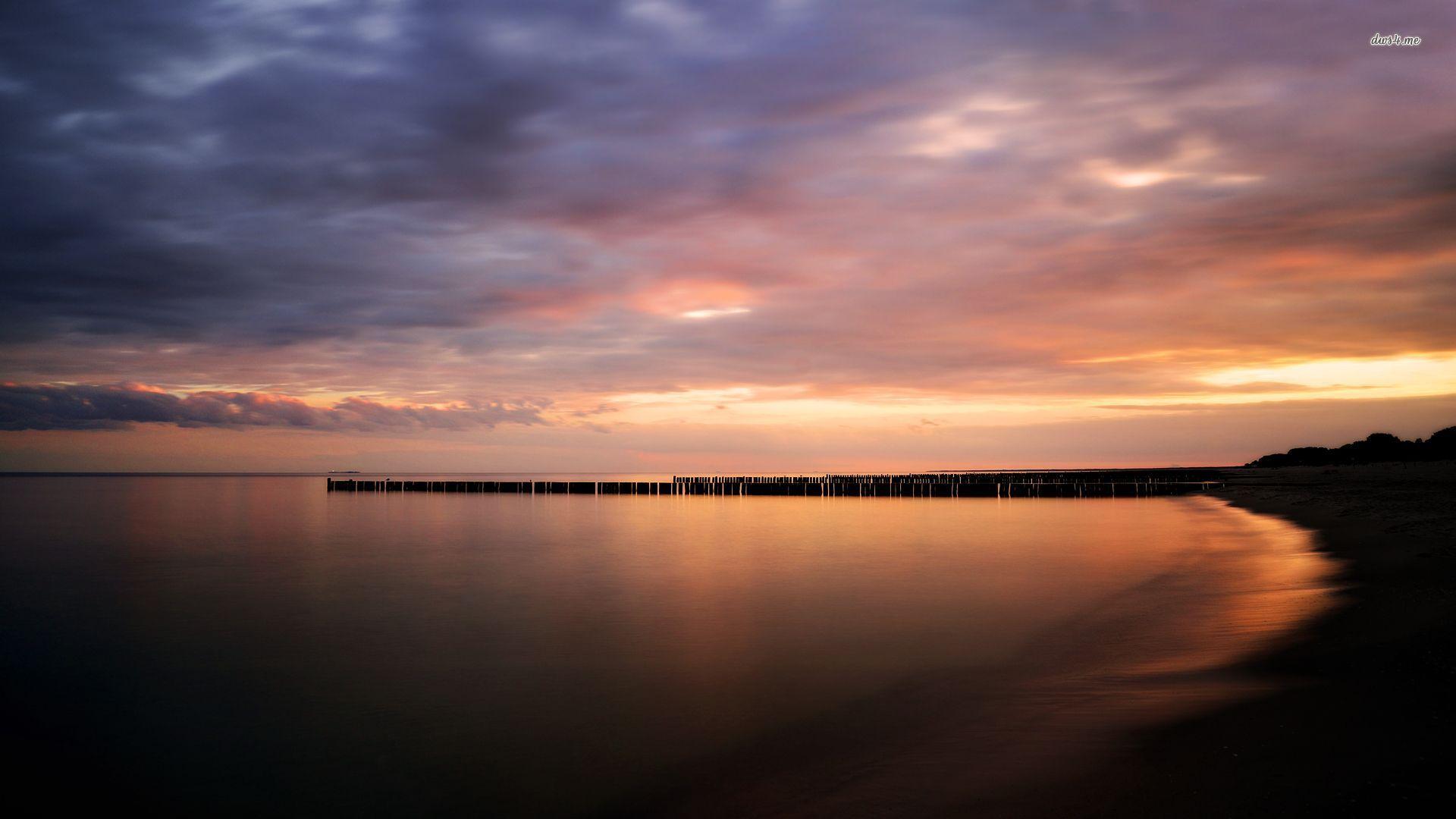 Wavebreaker silhouettes in the dusk light wallpaper