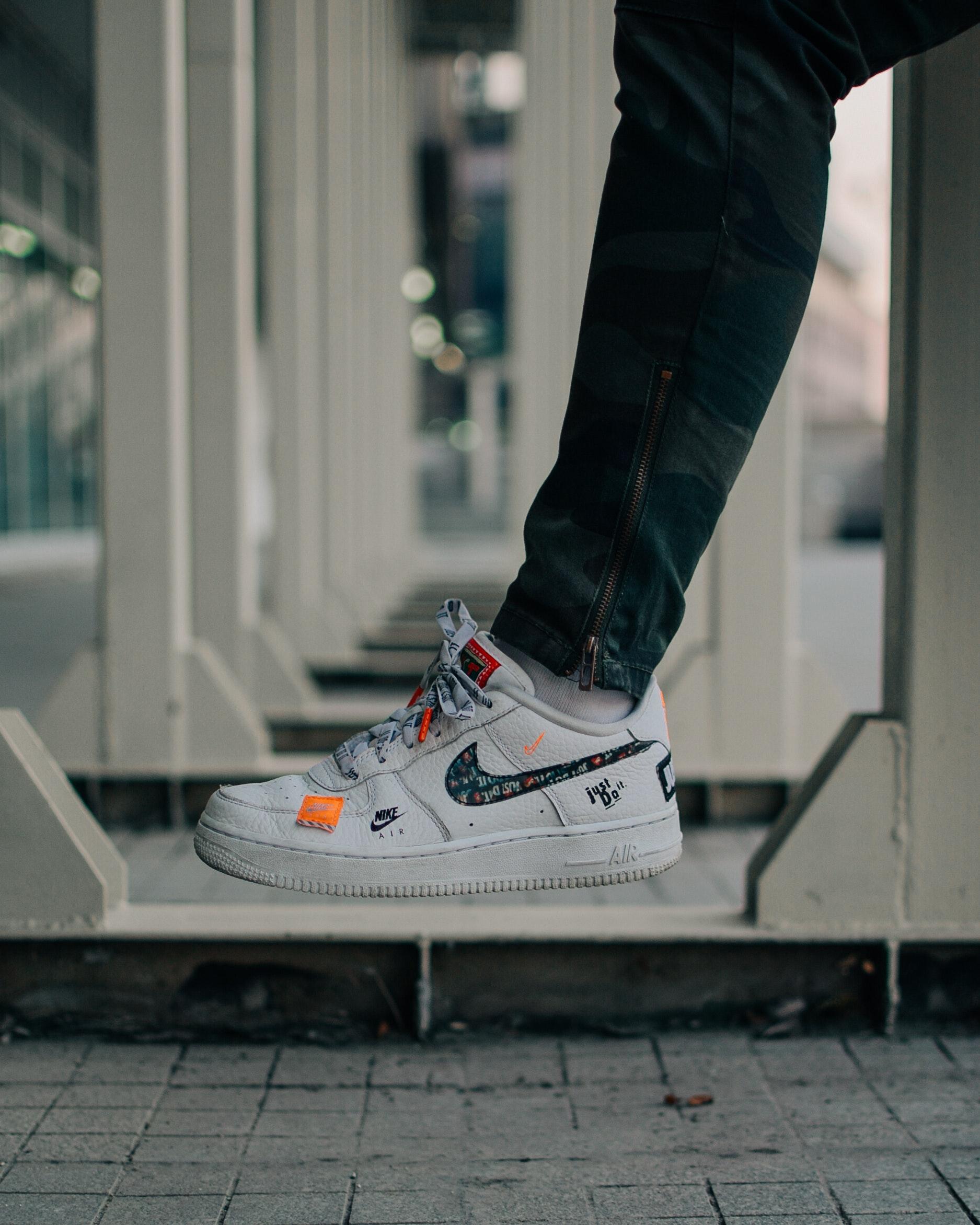 Selective Focus Photography Of Person Wearing Nike Air Force 1 Low